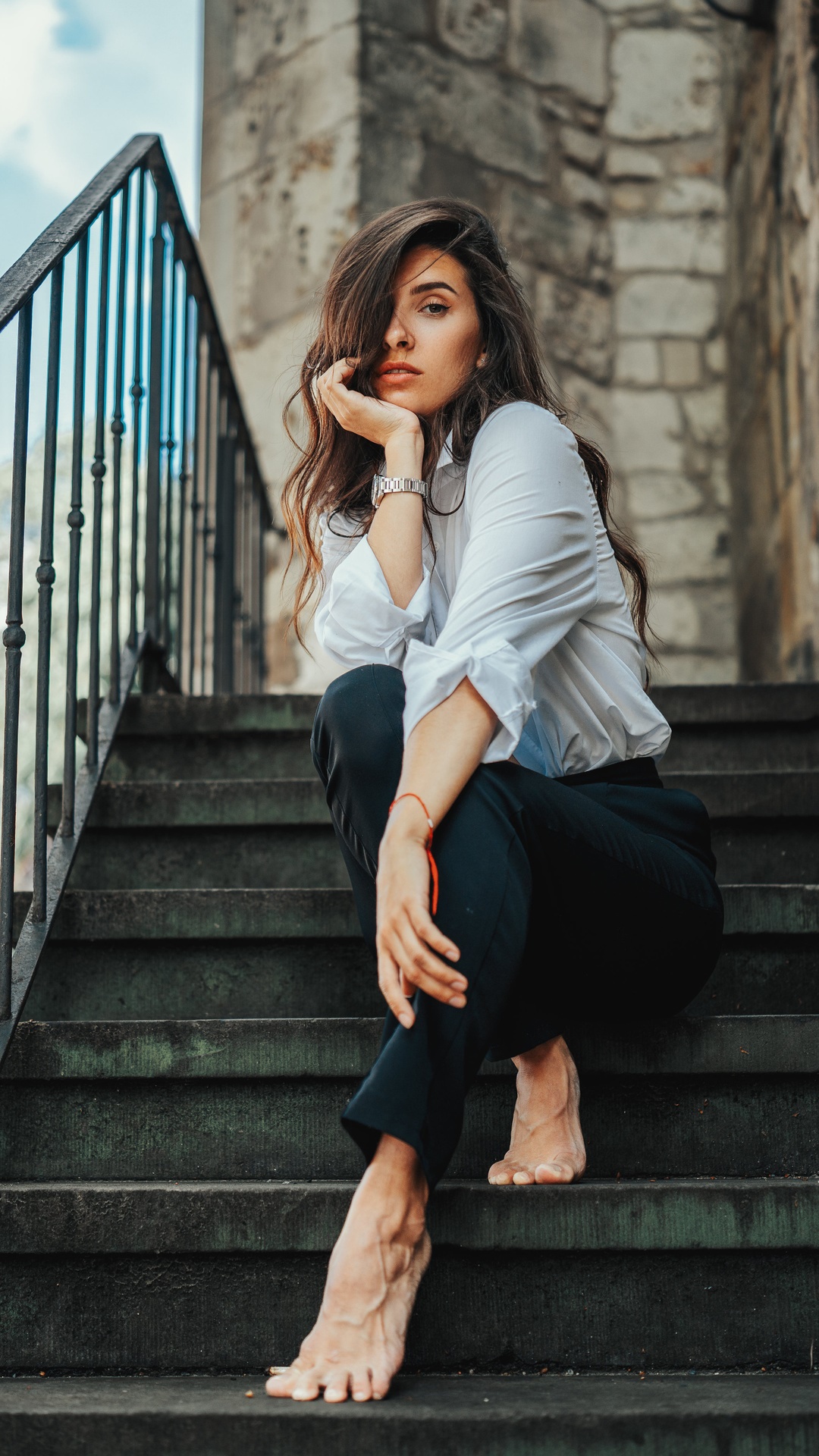 Woman in white shirt and black pants sitting on stairs HD Phone Wallpaper