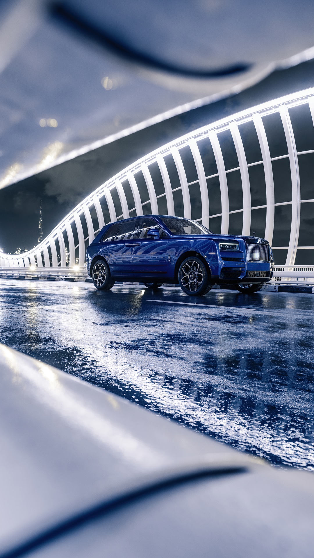 Blue Rolls Royce Cullinan on a Wet Road at Night HD Phone Wallpaper