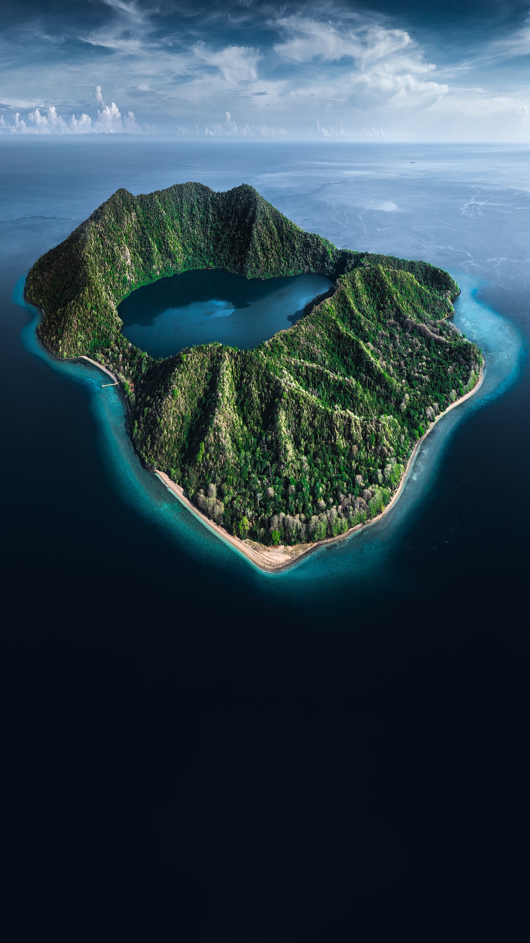 Aerial view of a volcanic island with a lake HD Phone Wallpaper