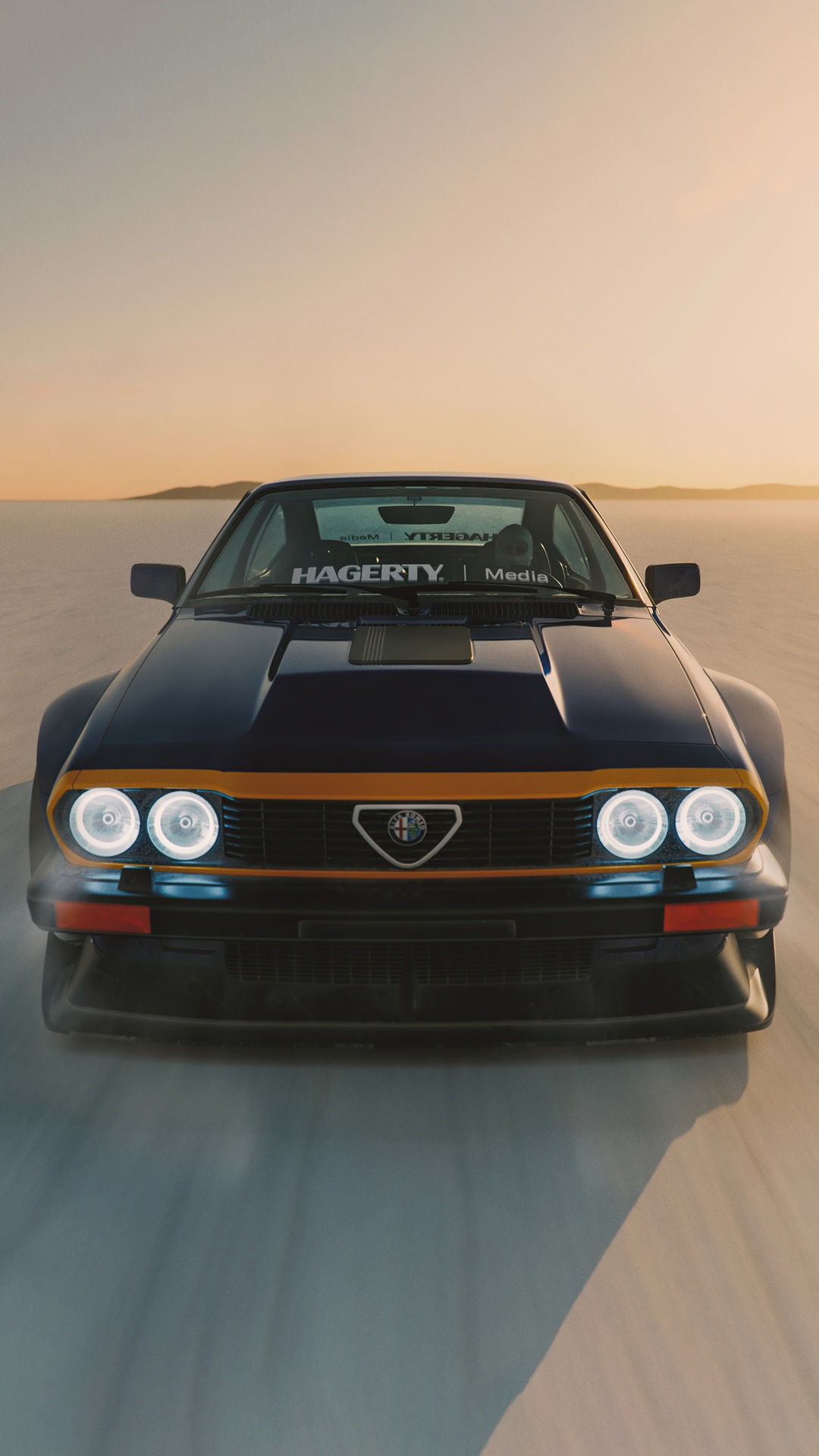 Alfa Romeo car on a salt flat at sunset HD Phone Wallpaper