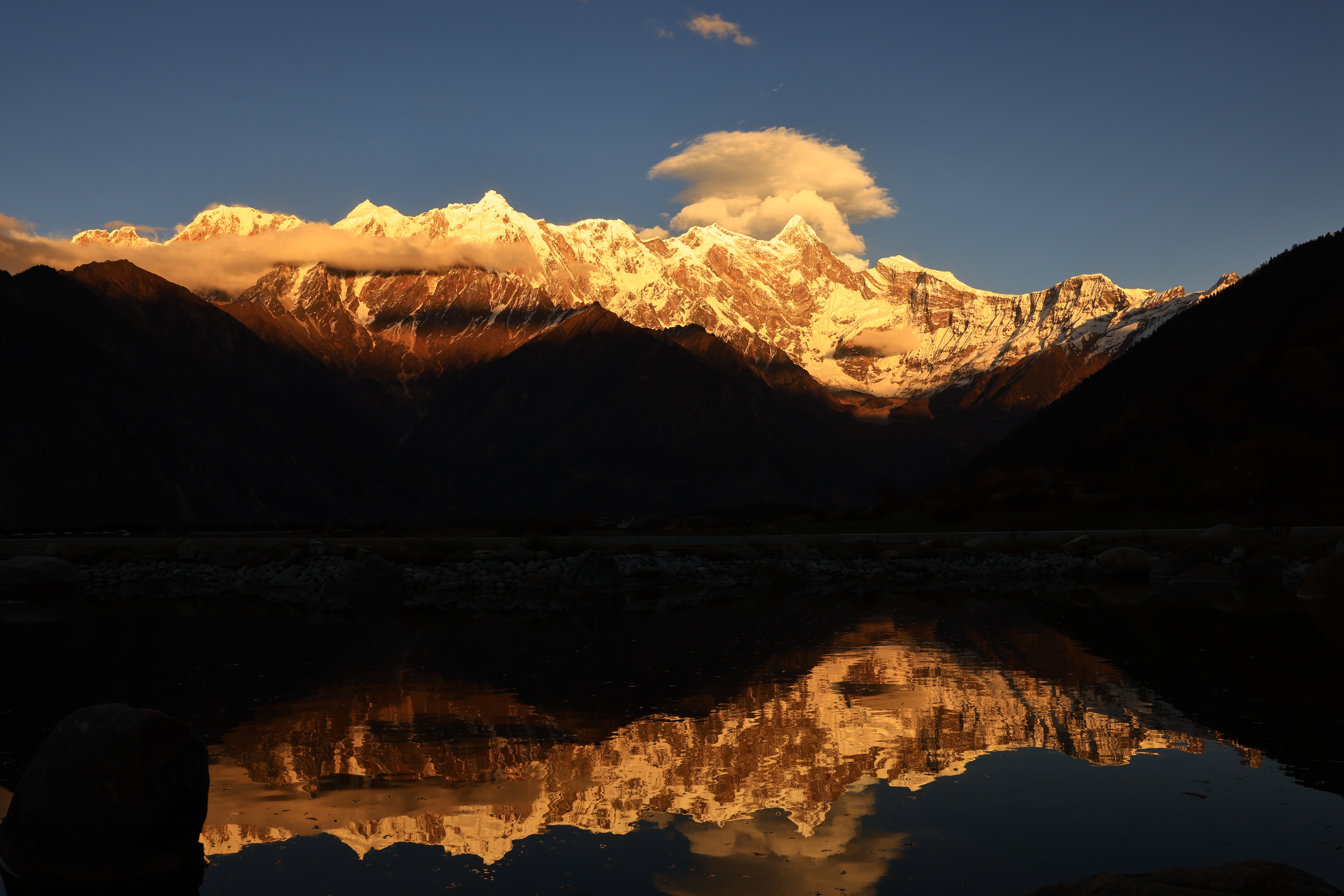 Snow-capped mountains reflecting in water at sunset HD Wallpaper