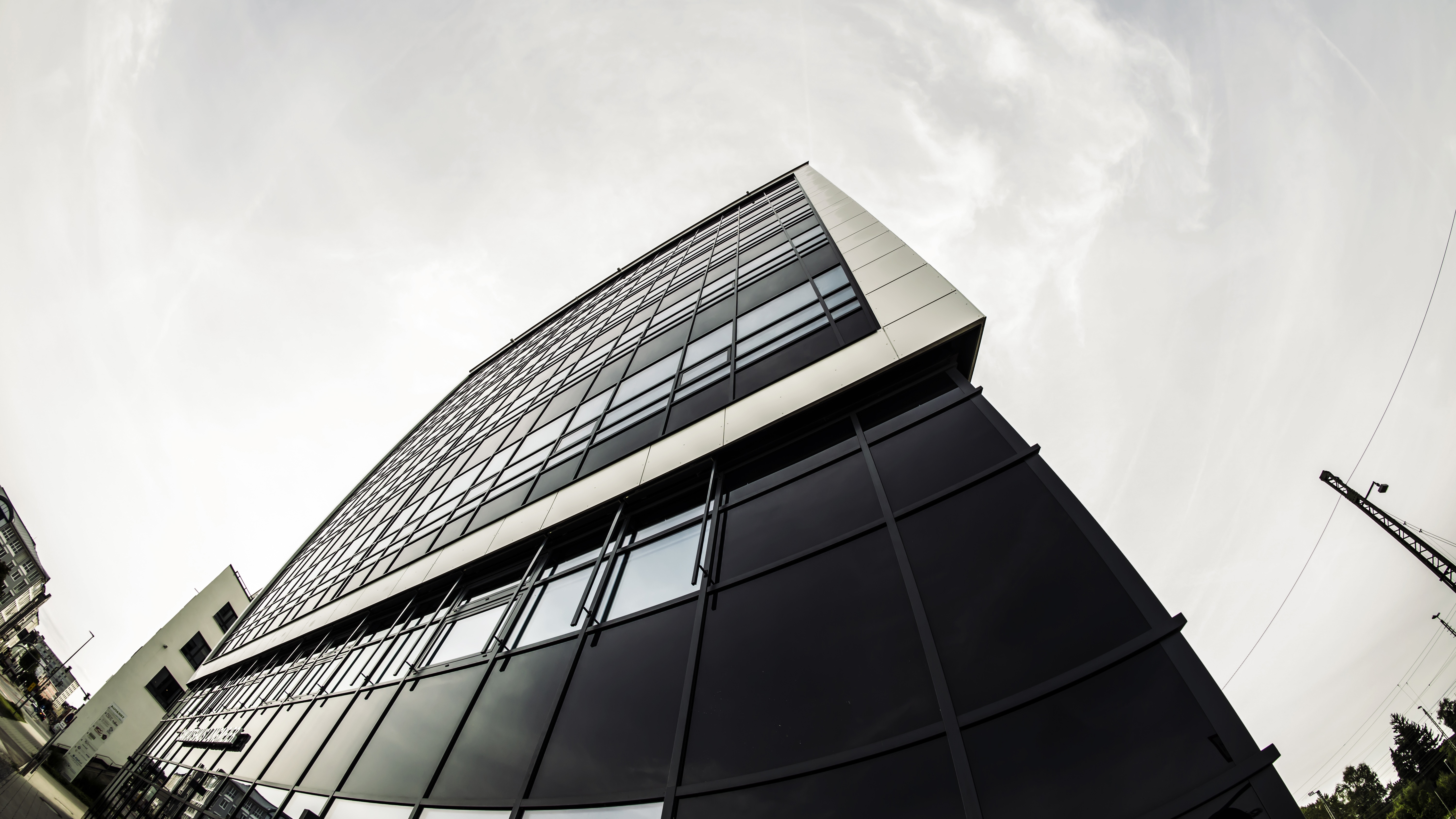 4K monochrome fisheye view of a modern building facade HD Wallpaper