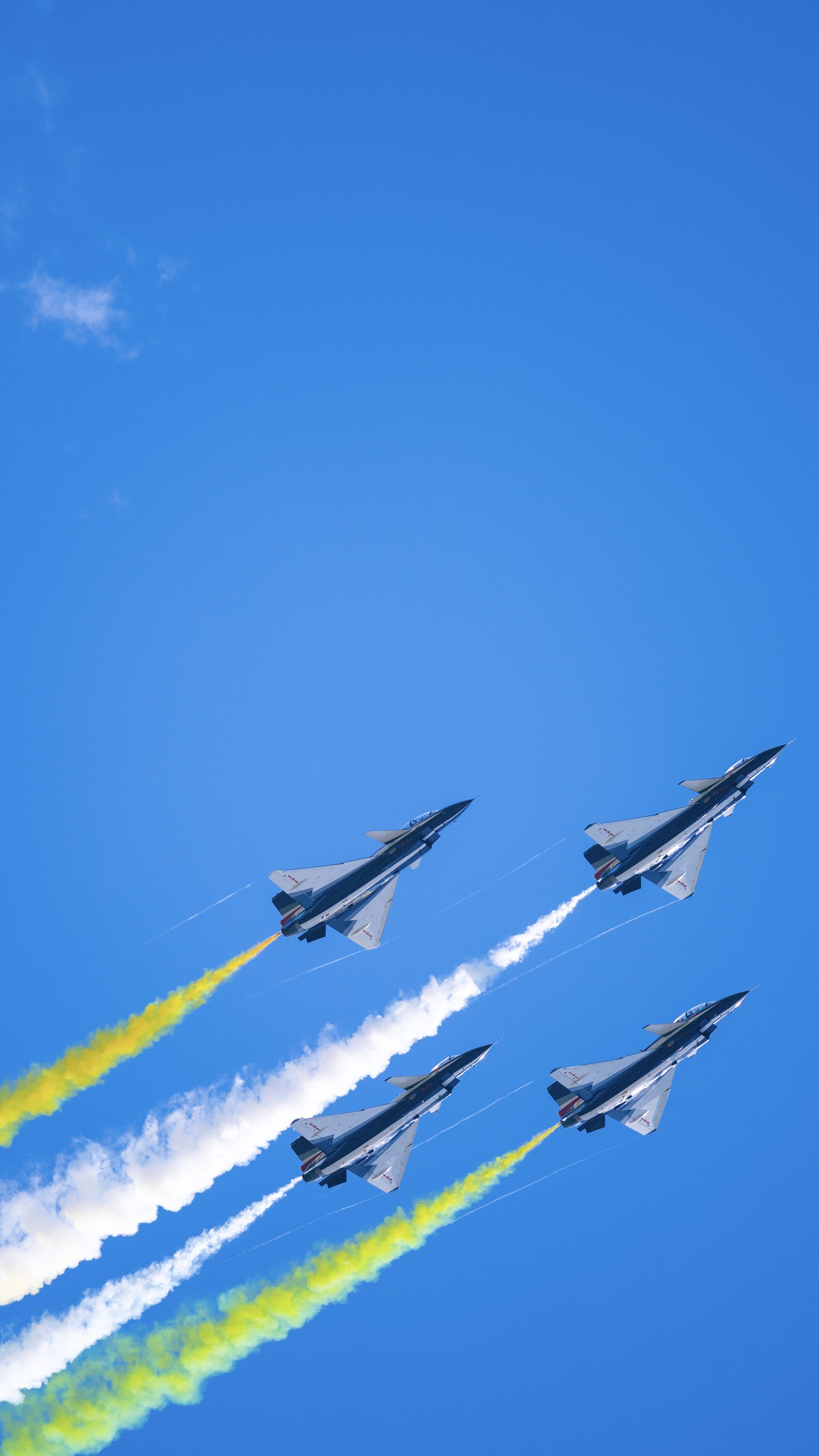 Four fighter jets flying in formation with colored smoke trails HD Phone Wallpaper