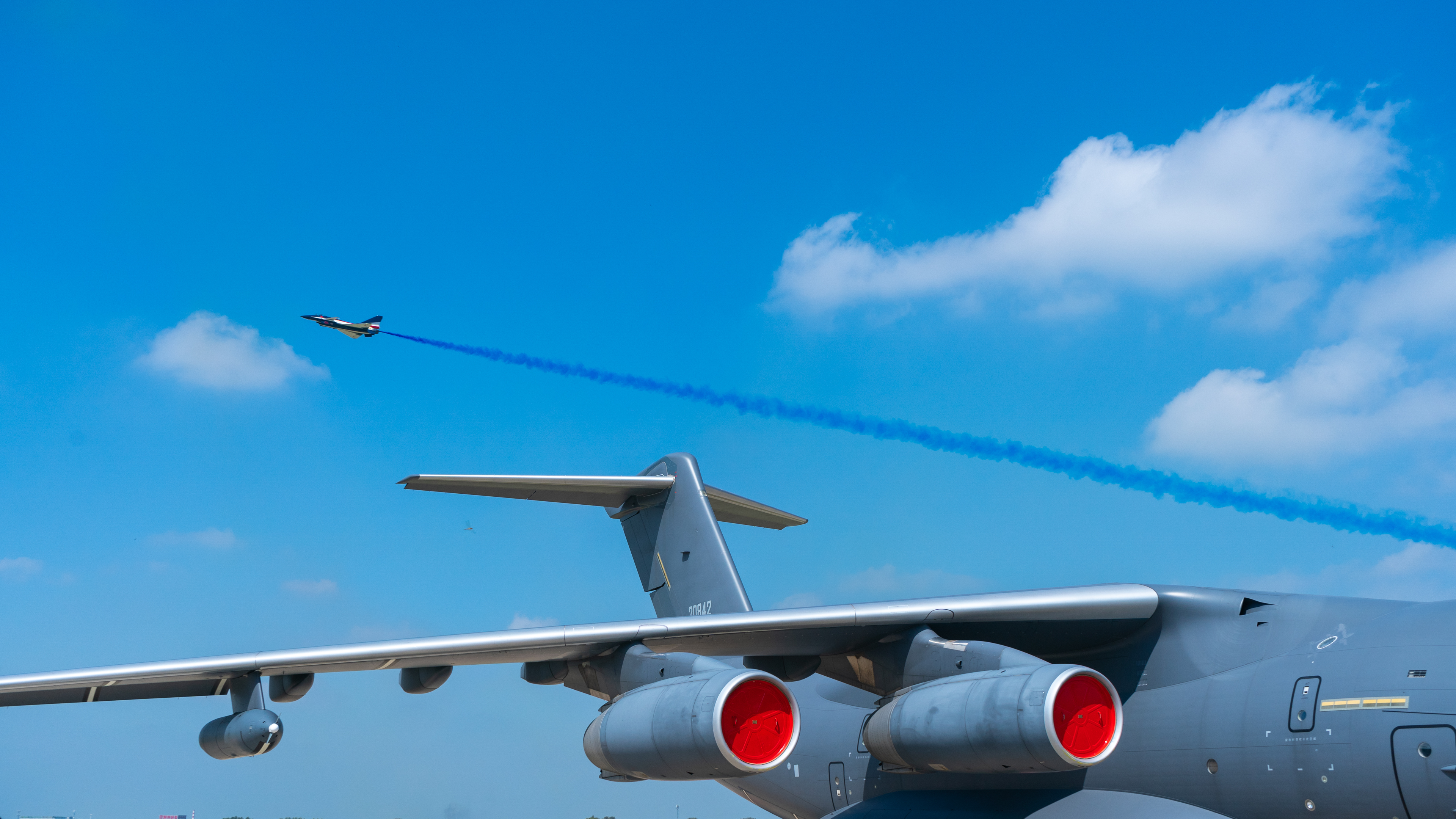 PLAAF military aircraft flying with blue smoke trails HD Wallpaper