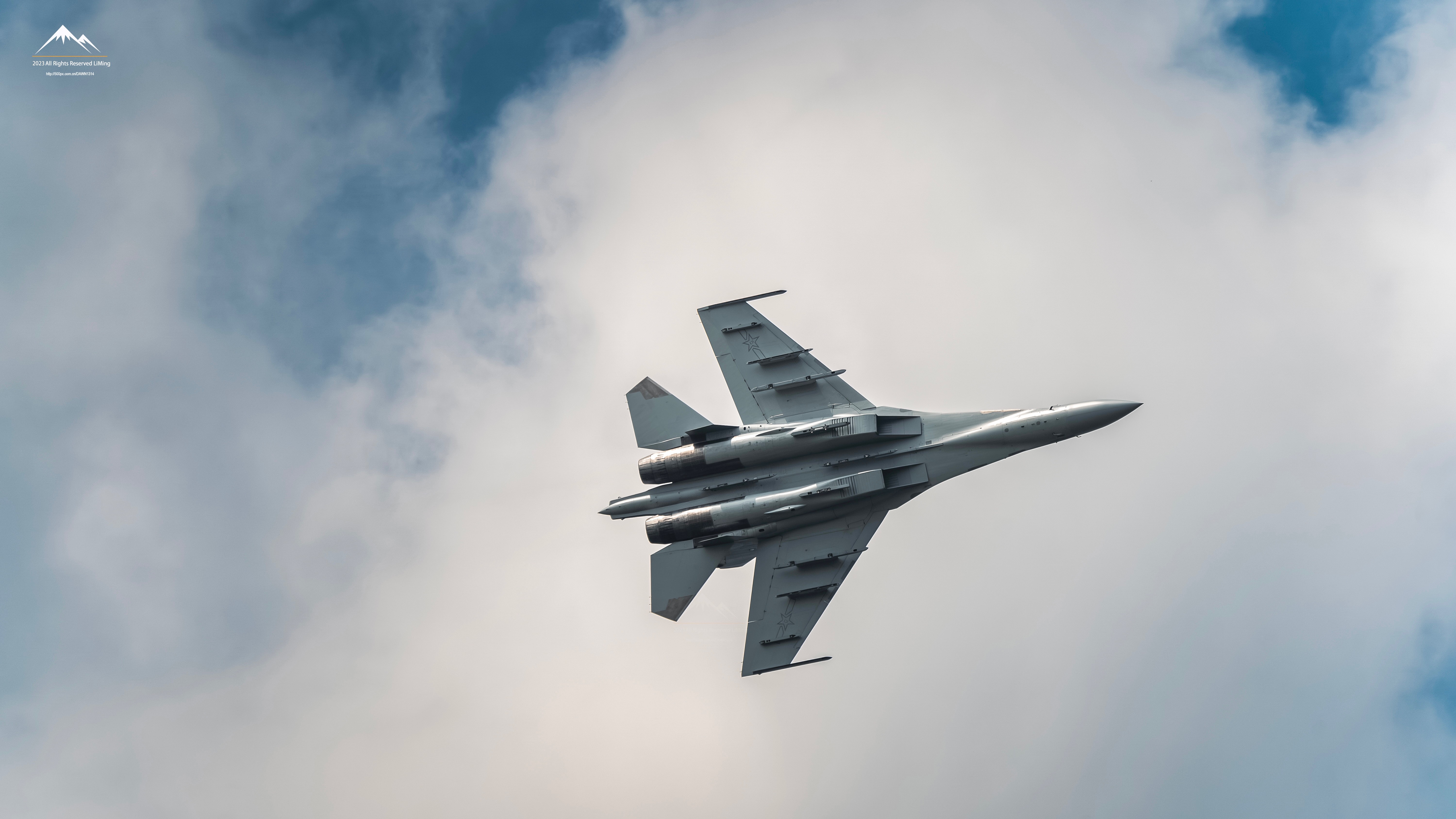 4K J-16 military aircraft flying through clouds HD Wallpaper