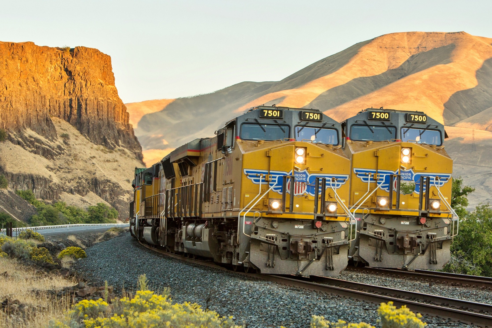 Union Pacific trains on a railway near a cliff HD Wallpaper