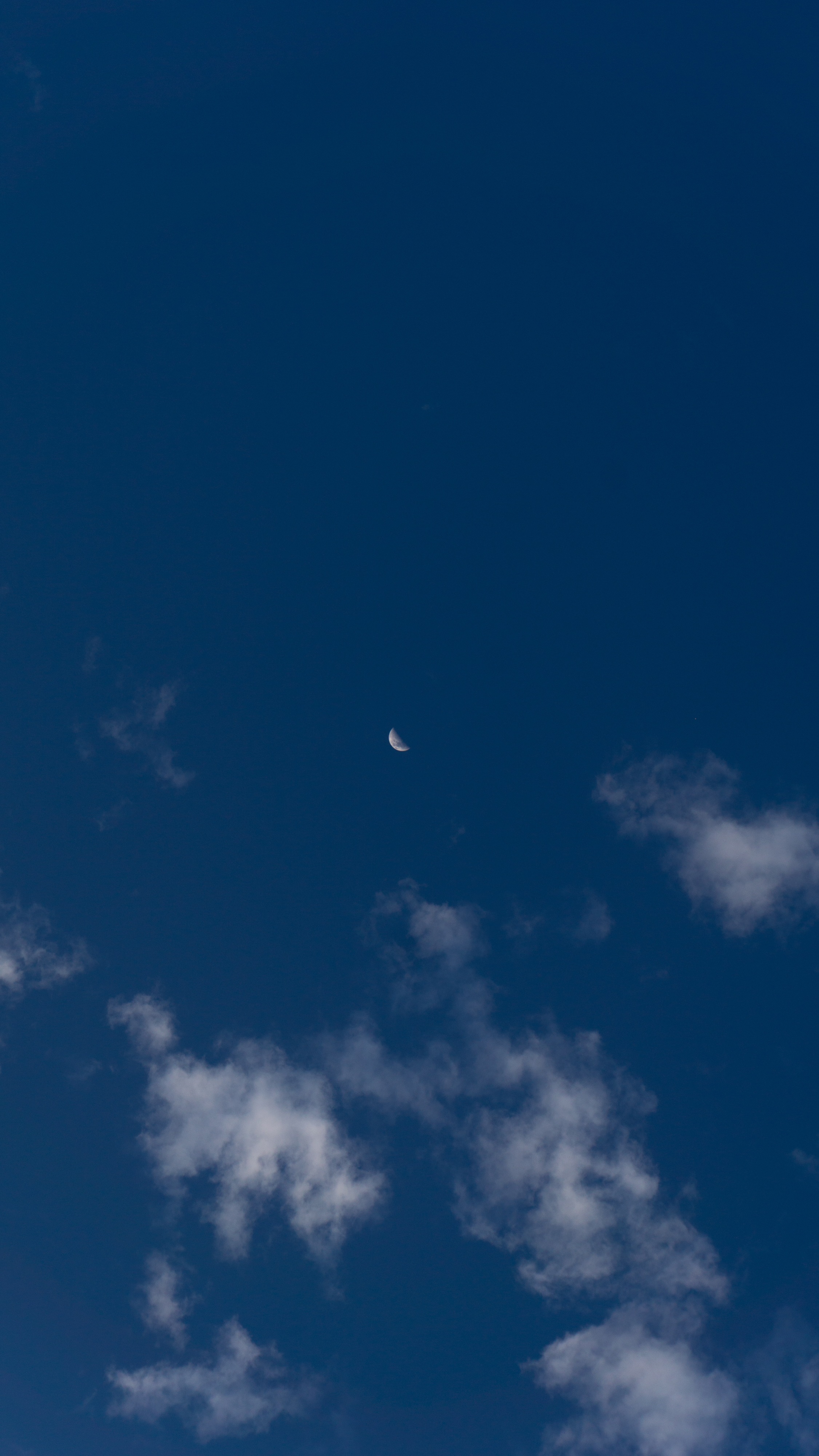 Crescent moon in a deep blue sky with clouds HD Phone Wallpaper