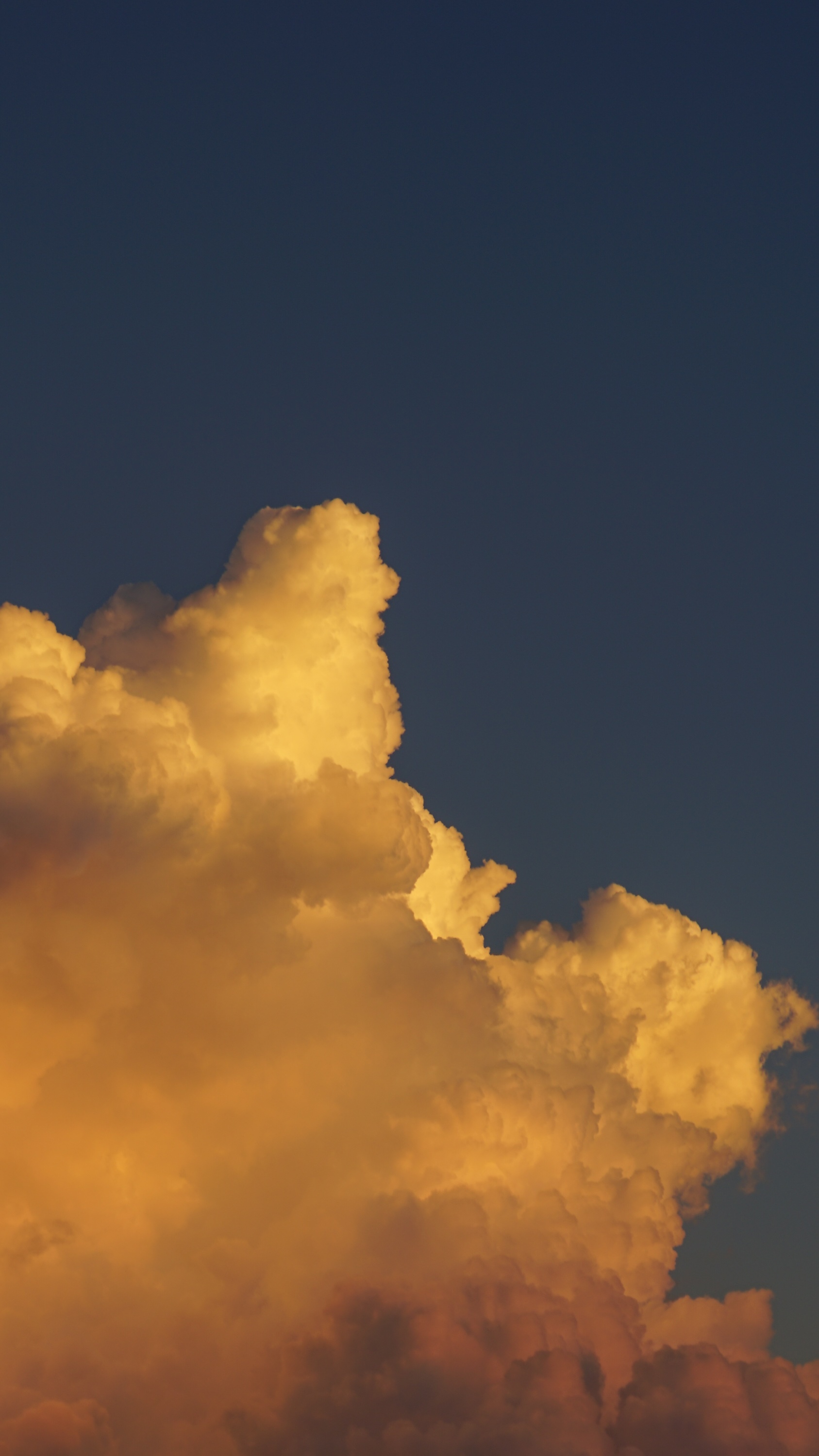 Golden clouds against a dark blue sky HD Phone Wallpaper