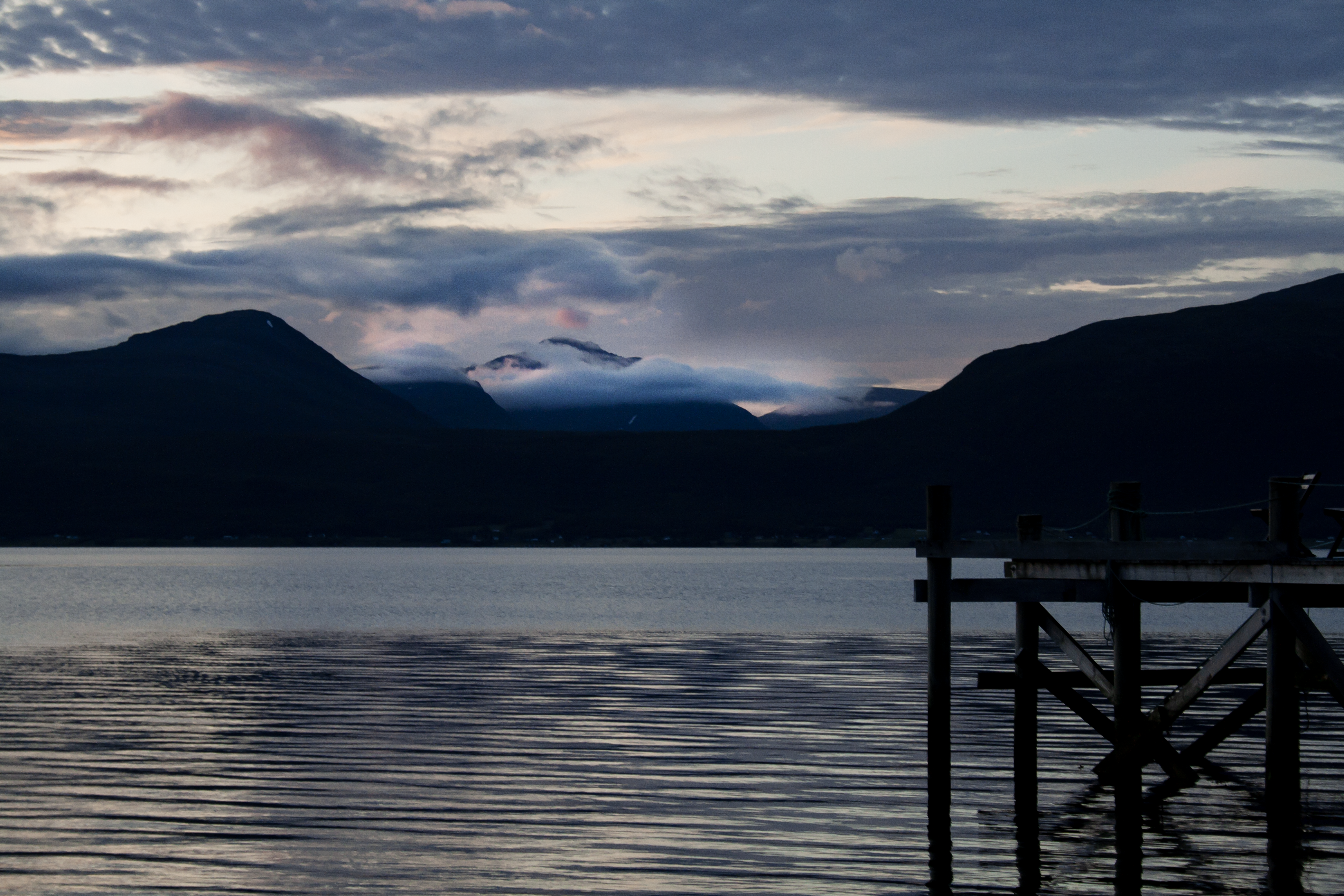 4K Norway landscape with mountains, clouds, and a dock HD Wallpaper