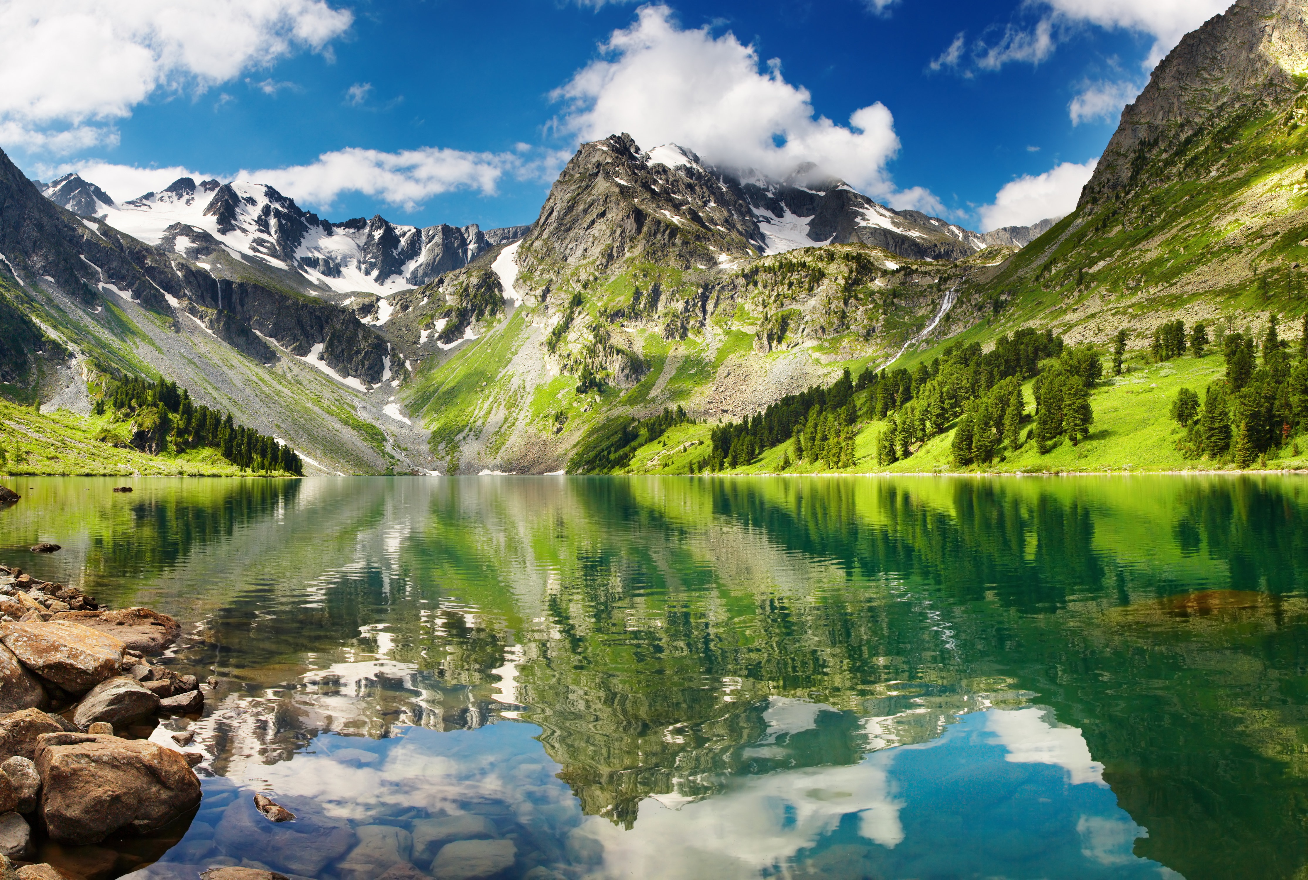 Mountains reflected in a clear lake with snow and trees HD Wallpaper