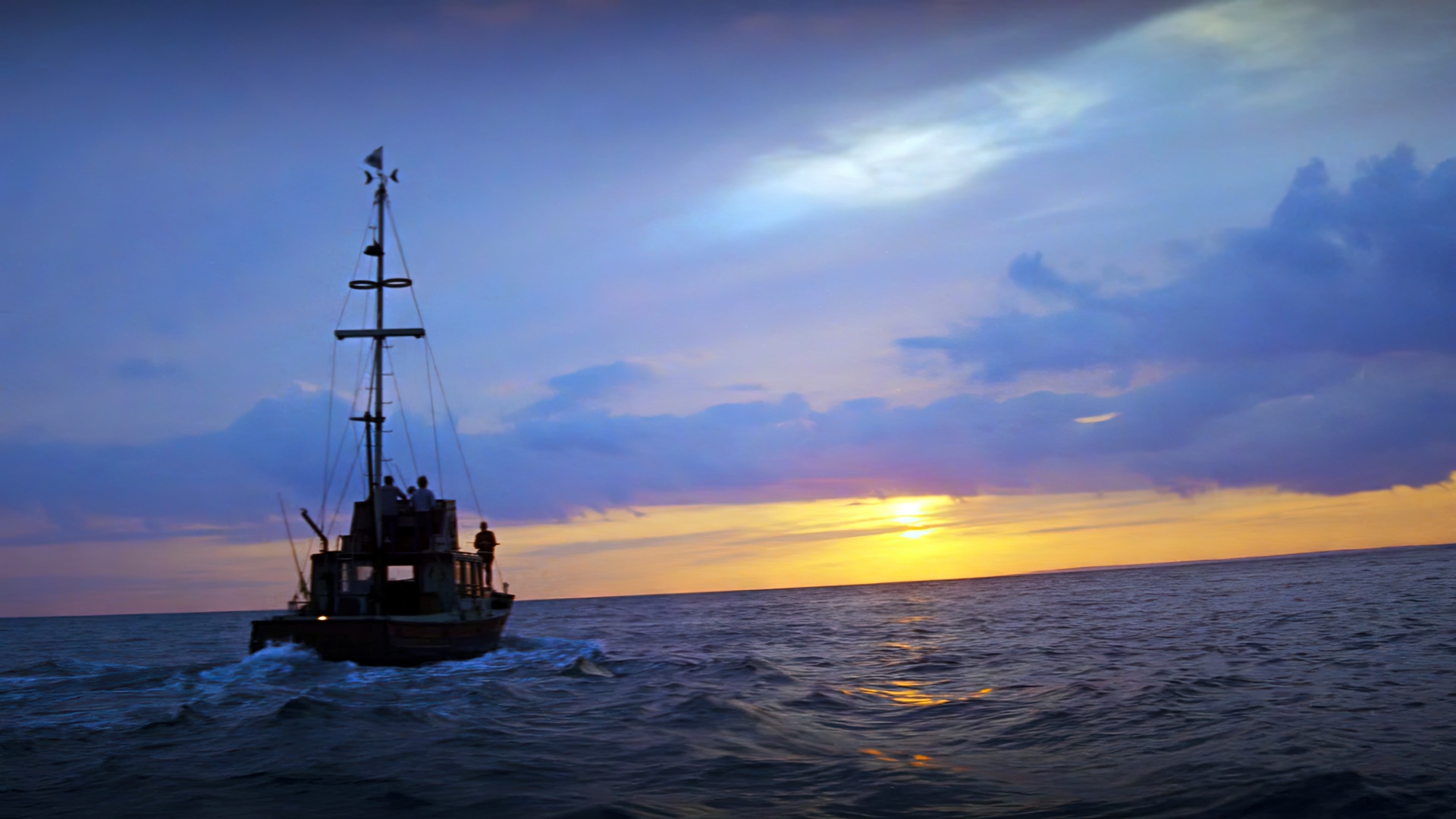 Boat sailing at sunset with dramatic clouds HD Wallpaper