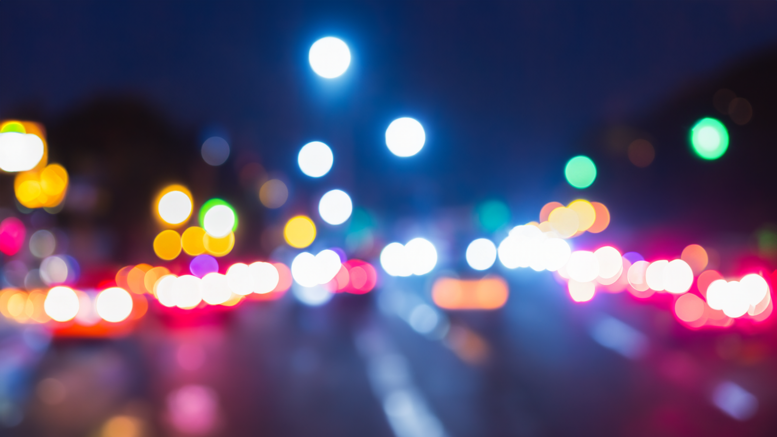 Blurry city lights at night with traffic HD Wallpaper