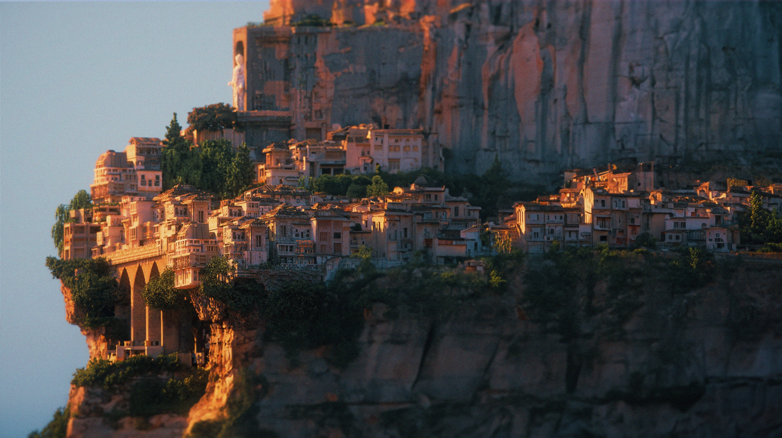 City built on a cliffside with ancient architecture HD Wallpaper