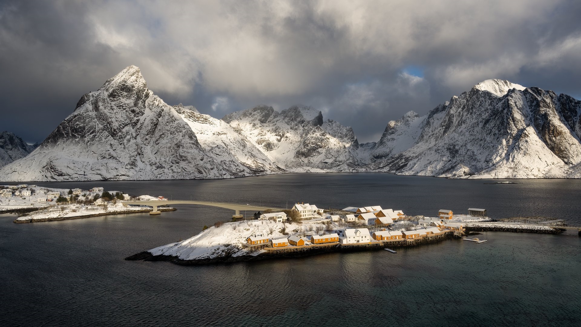 Snowy Lofoten village with mountains and fjord HD Wallpaper