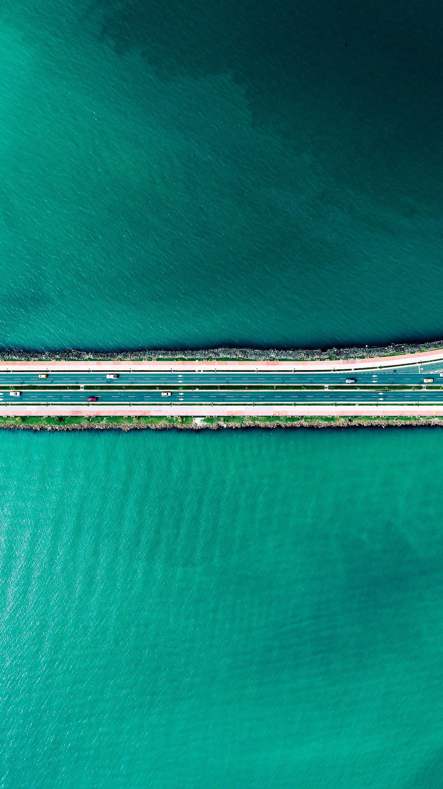 Aerial view of a highway bridge over turquoise water HD Phone Wallpaper