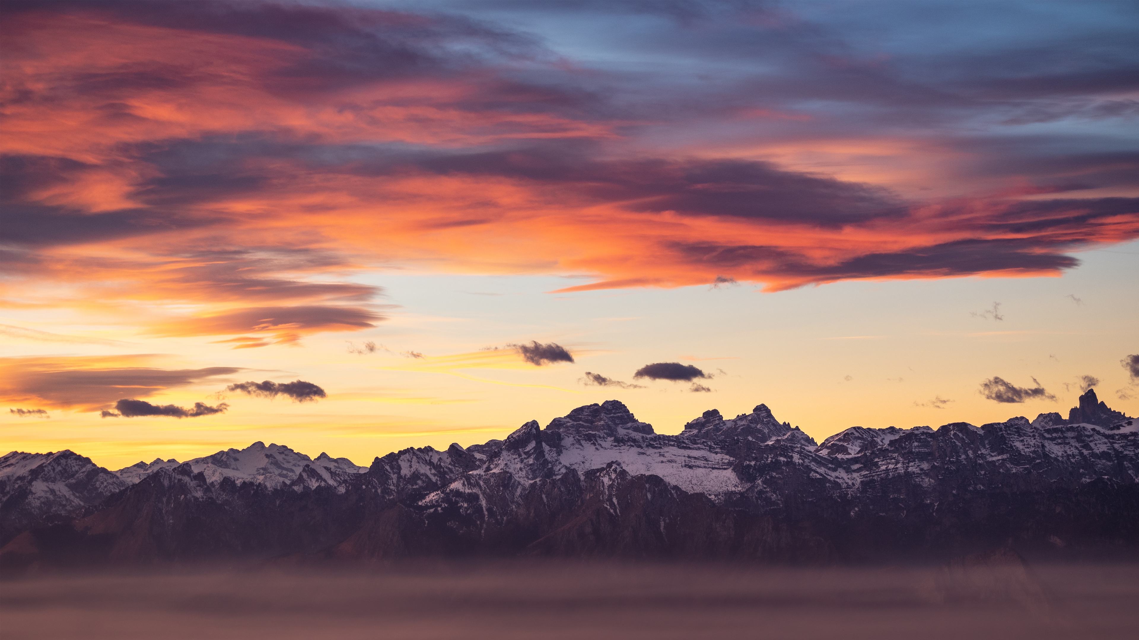4K Sunset Over Snowy Mountains with Clouds HD Wallpaper