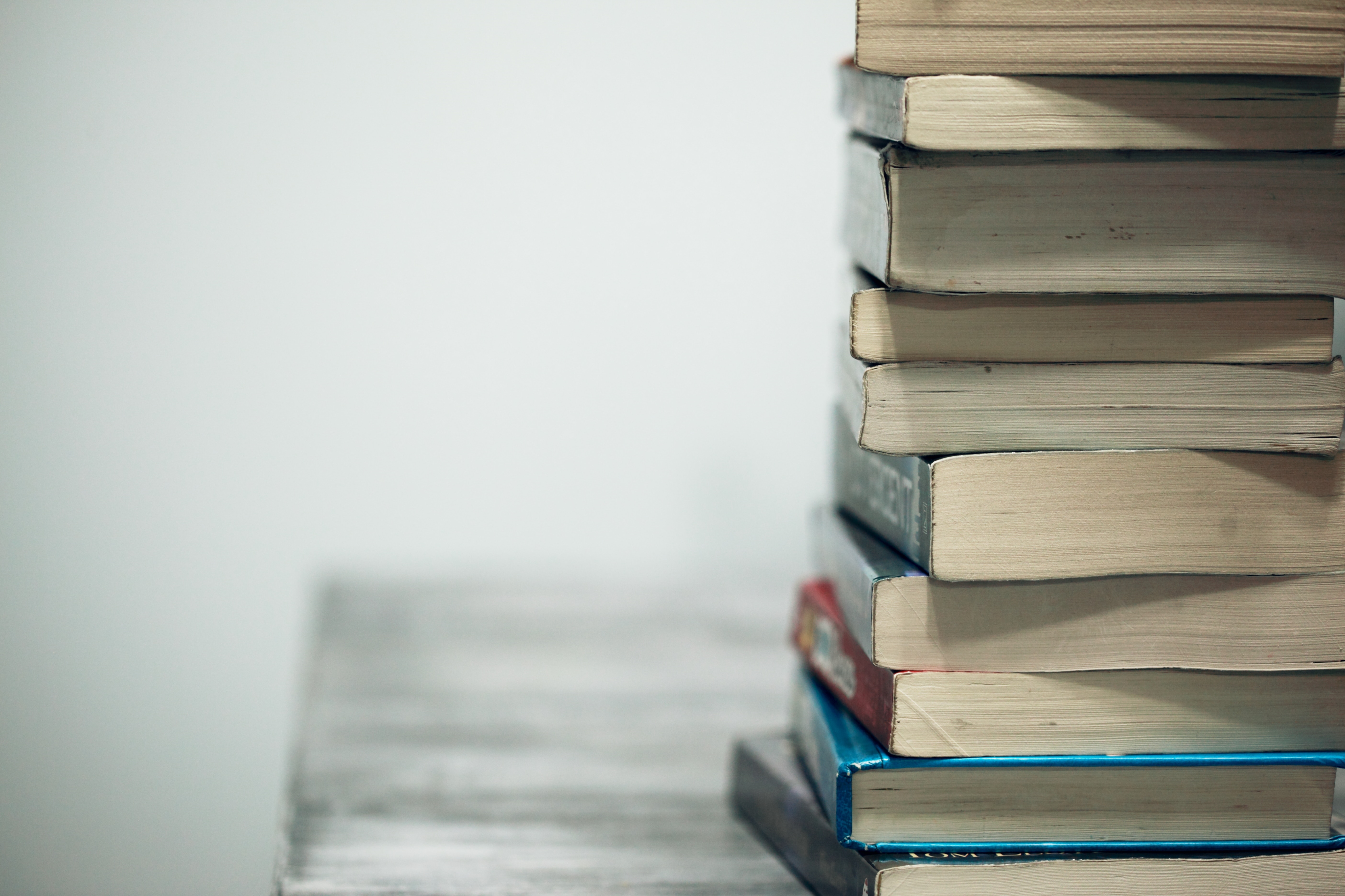Stack of books on a table HD Wallpaper
