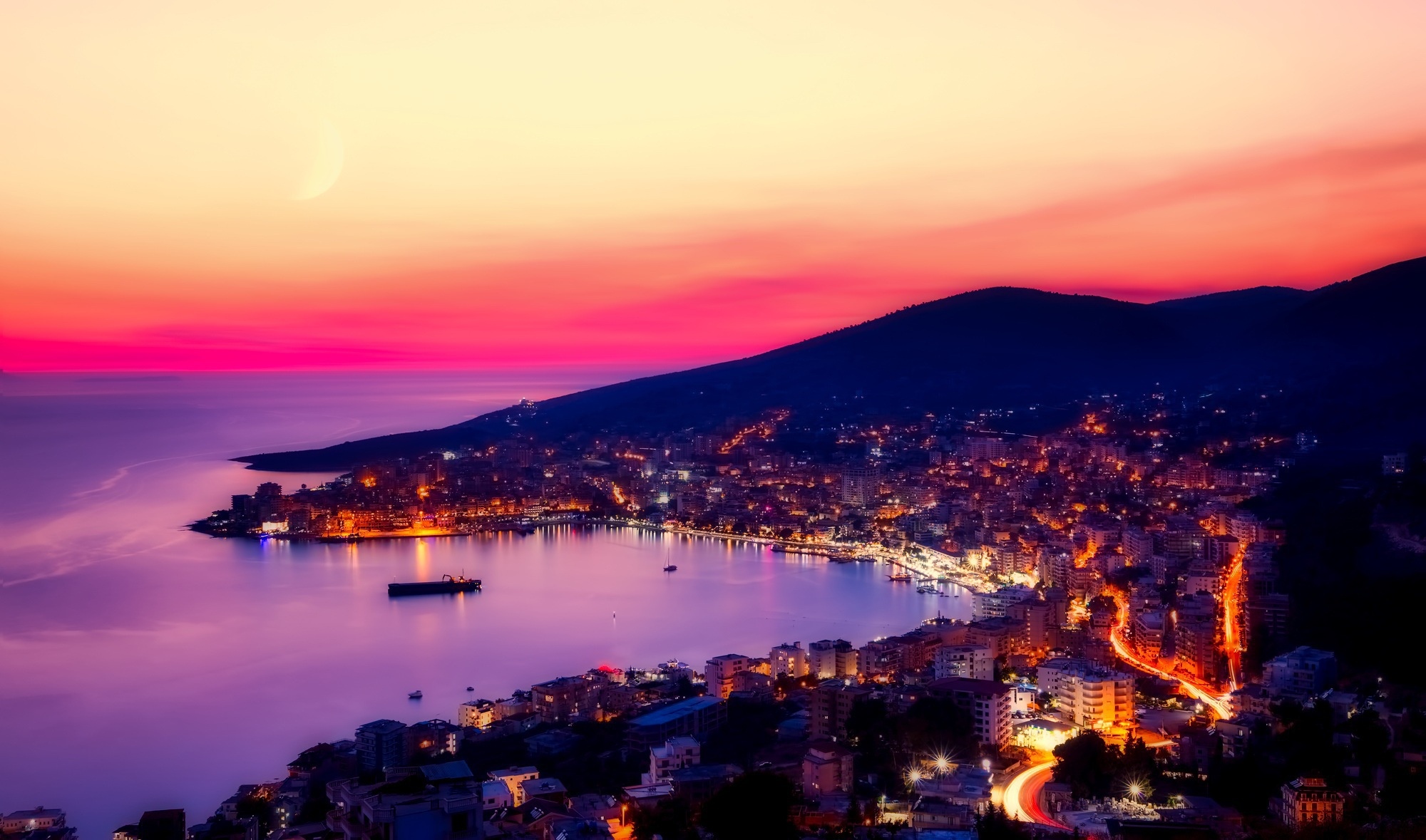 Cityscape of Albania at sunset with mountains and sea HD Wallpaper