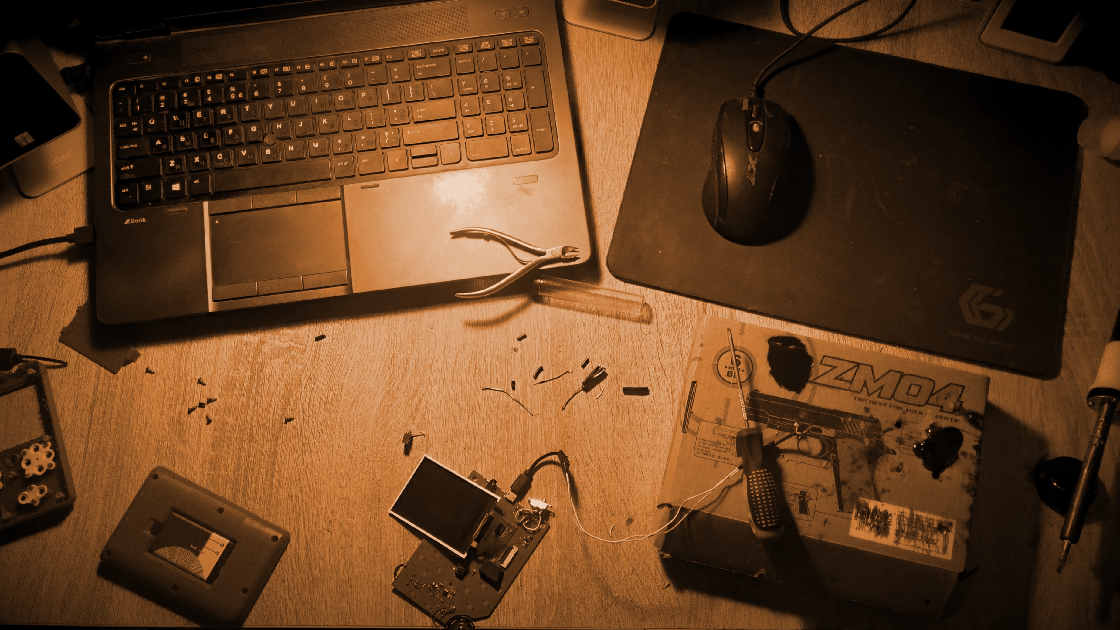Laptop and electronics on a wooden desk HD Wallpaper