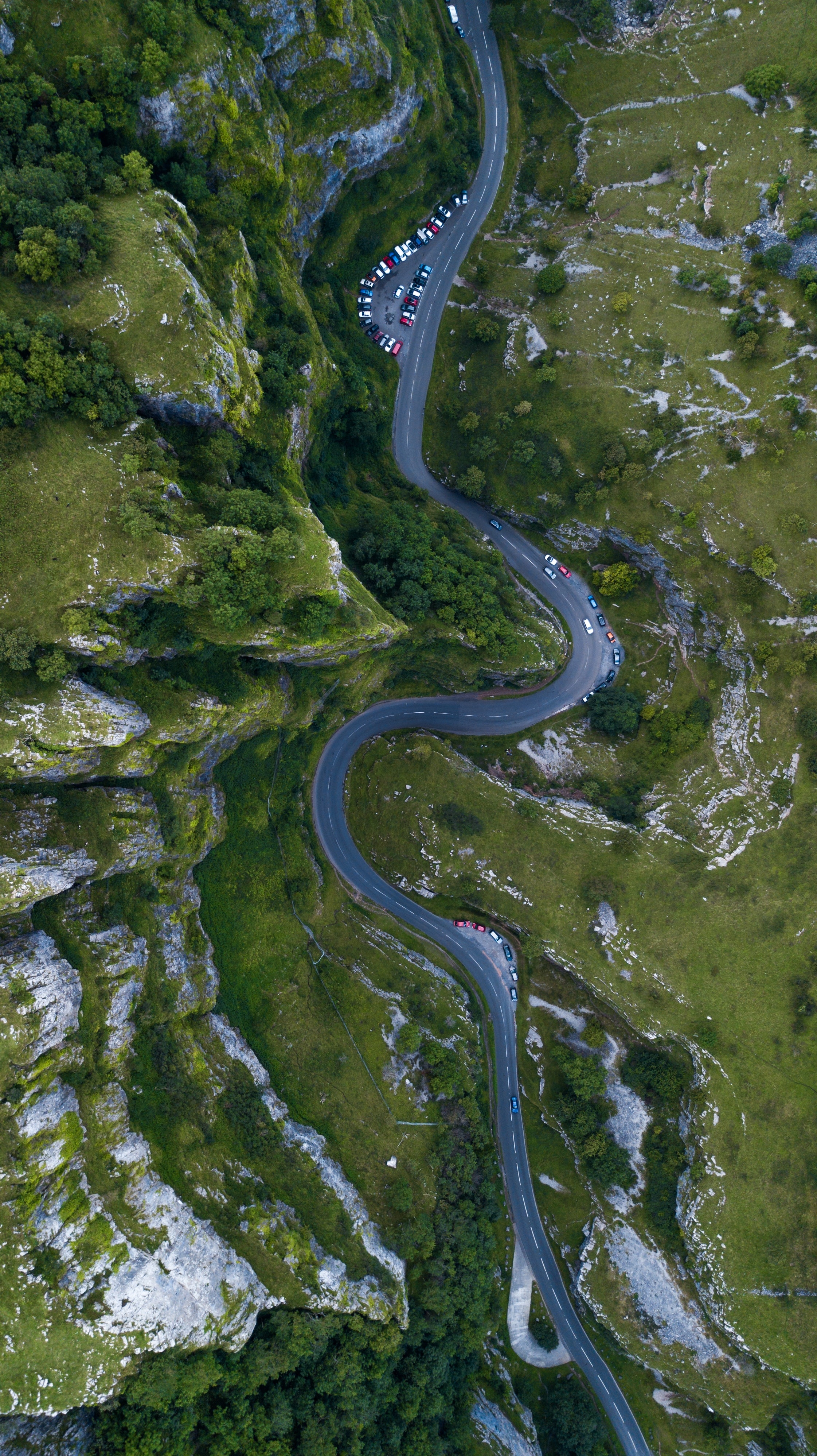 Aerial view of a winding road through a gorge in England HD Phone Wallpaper