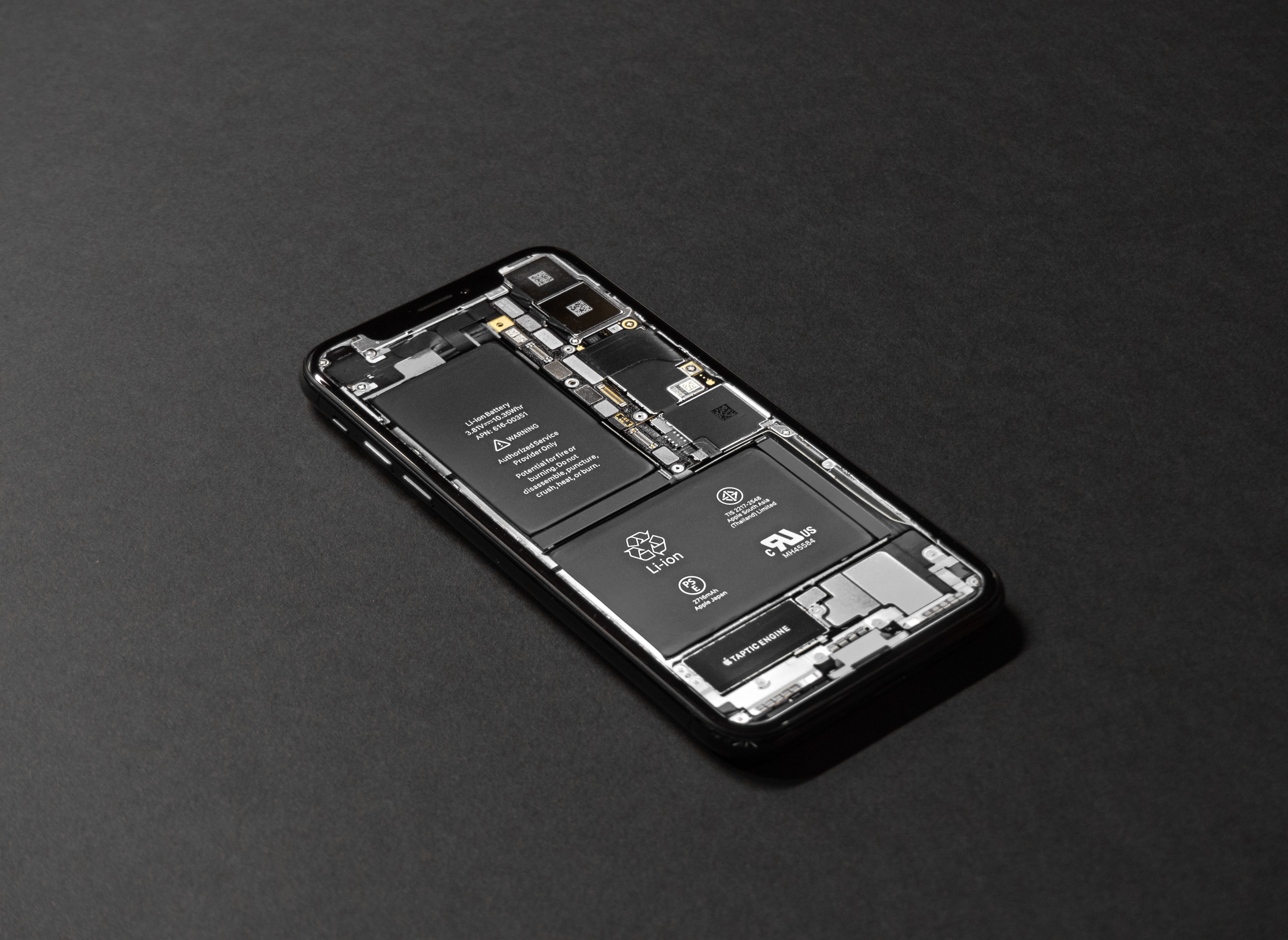 iPhone disassembled showing internal components and battery HD Wallpaper