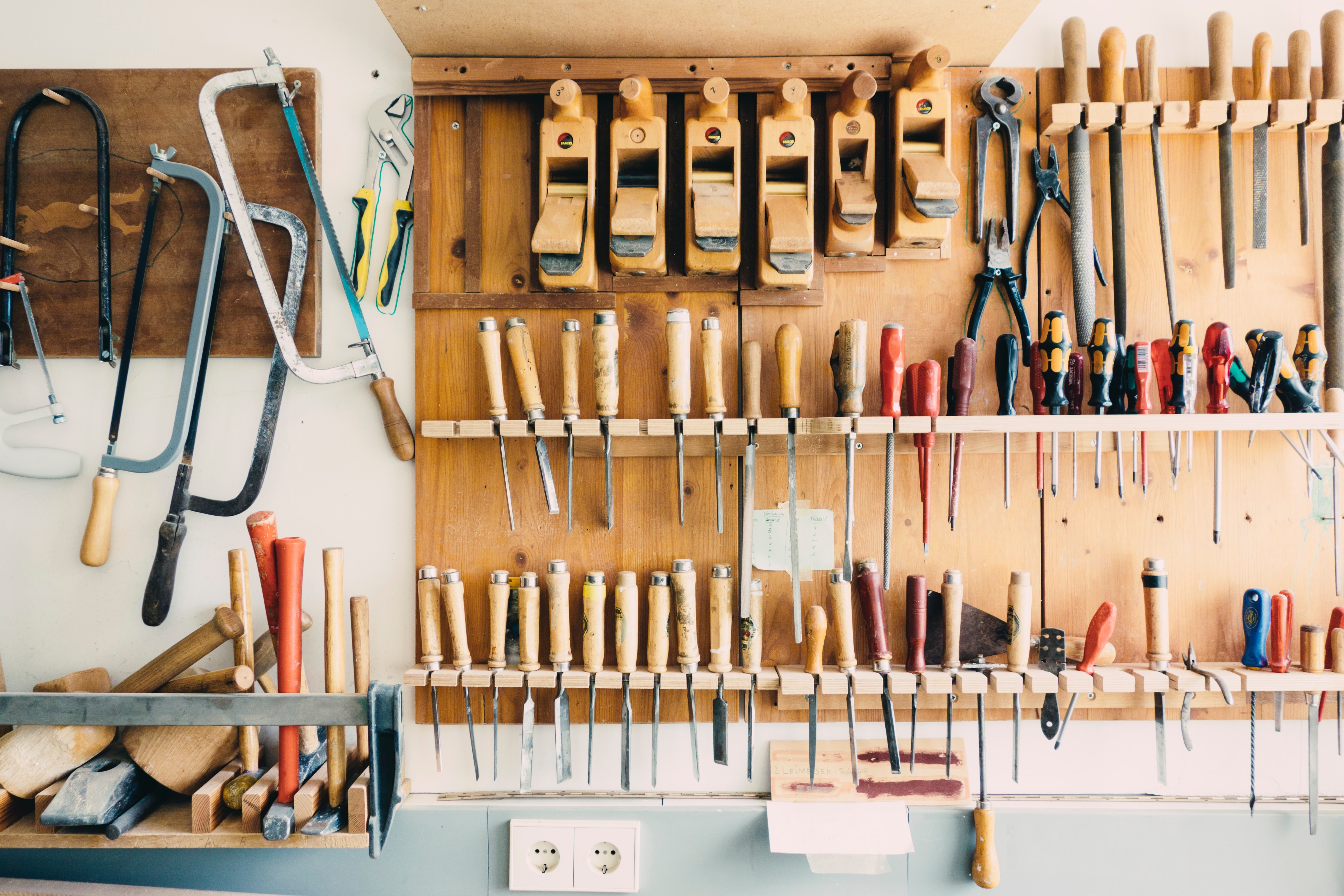 Organized workshop with carpentry tools on the wall HD Wallpaper