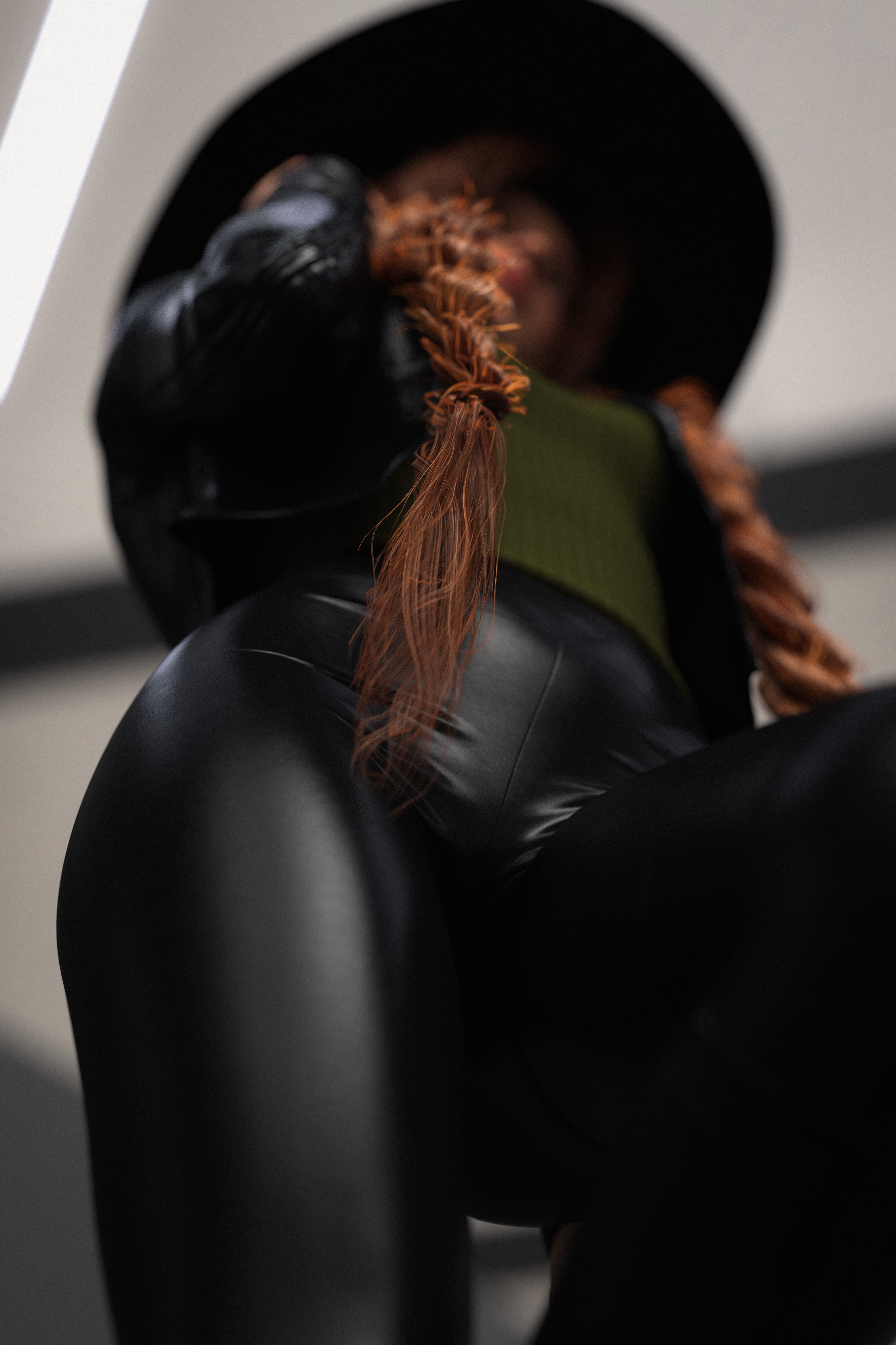 Woman in hat and leather pants, bottom view HD Phone Wallpaper