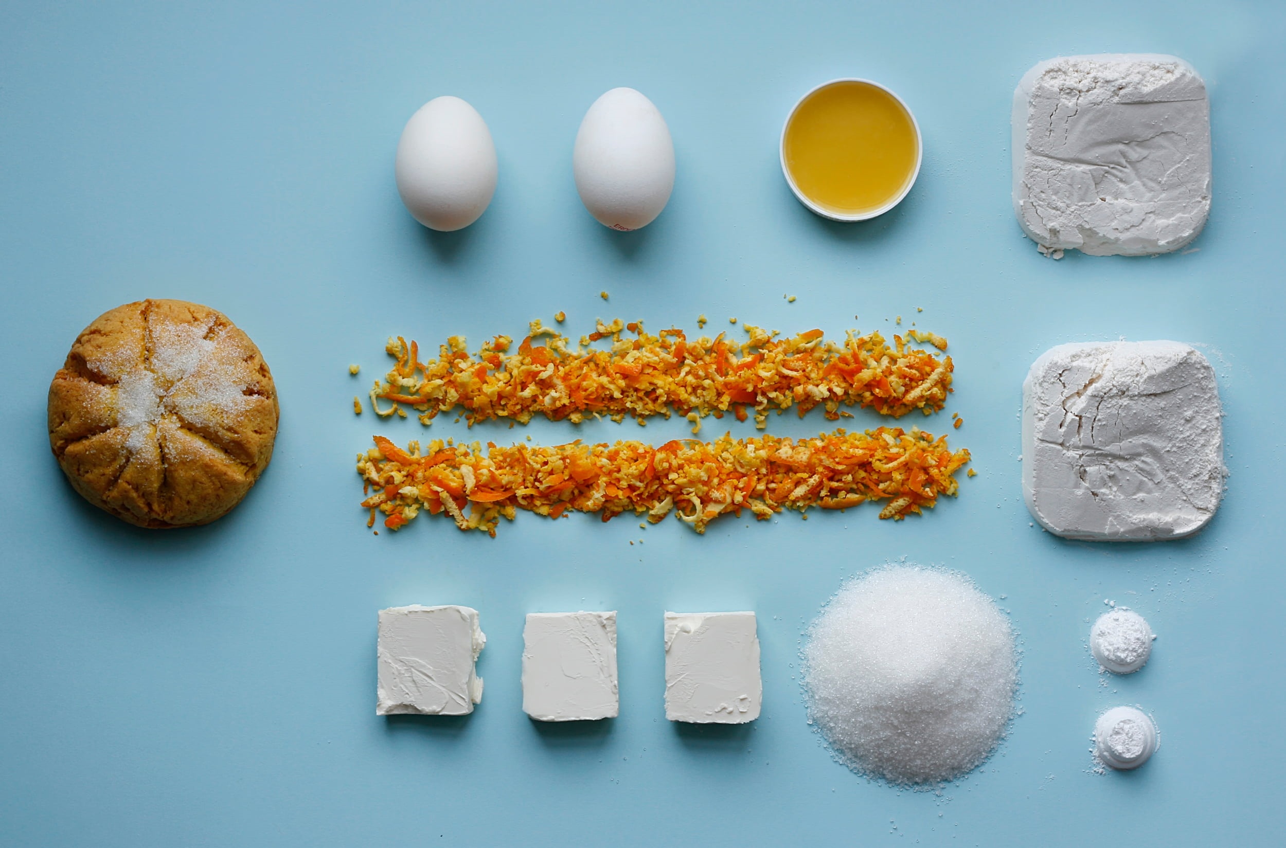 Baking ingredients laid out on a blue surface HD Wallpaper