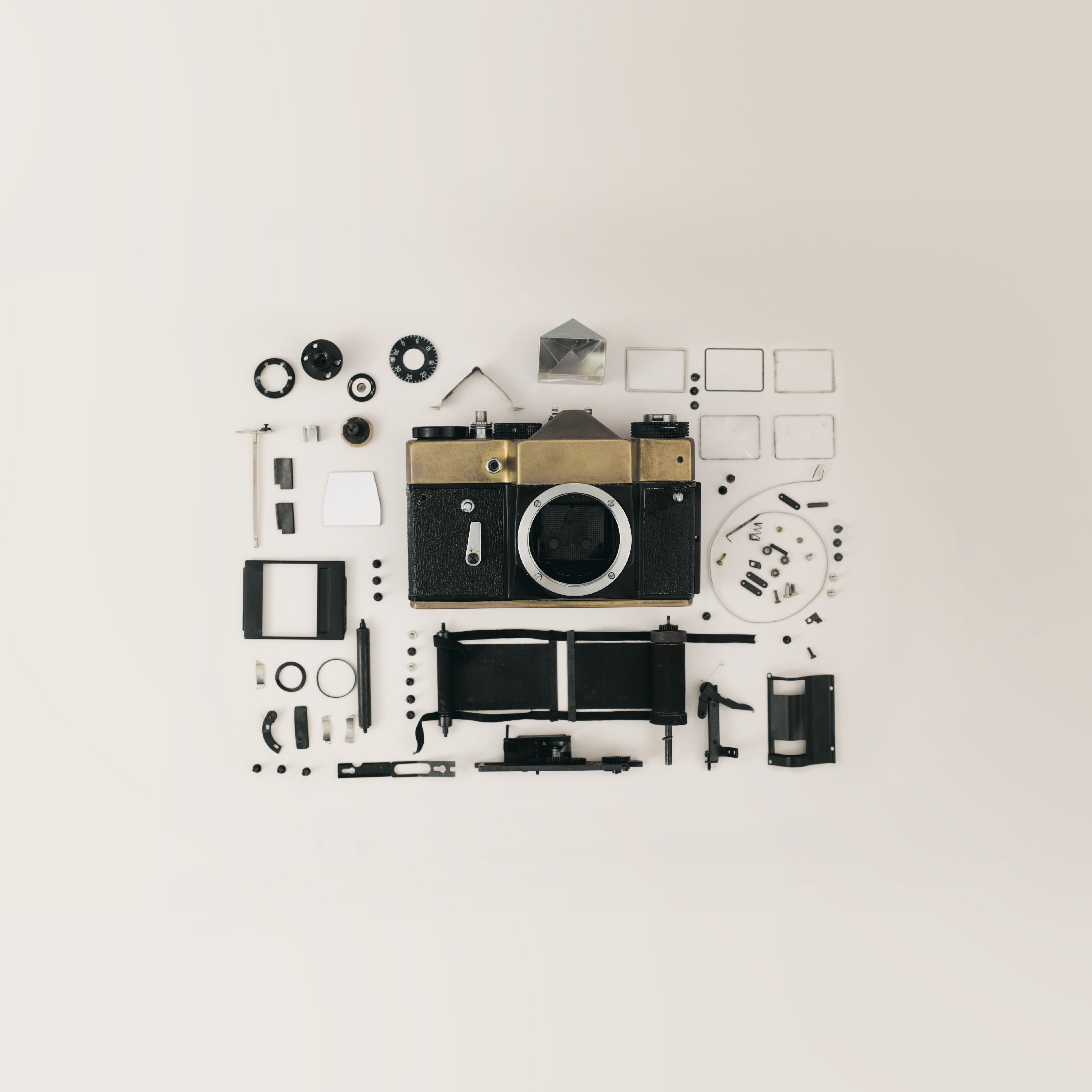 Disassembled vintage camera with parts laid out HD Wallpaper