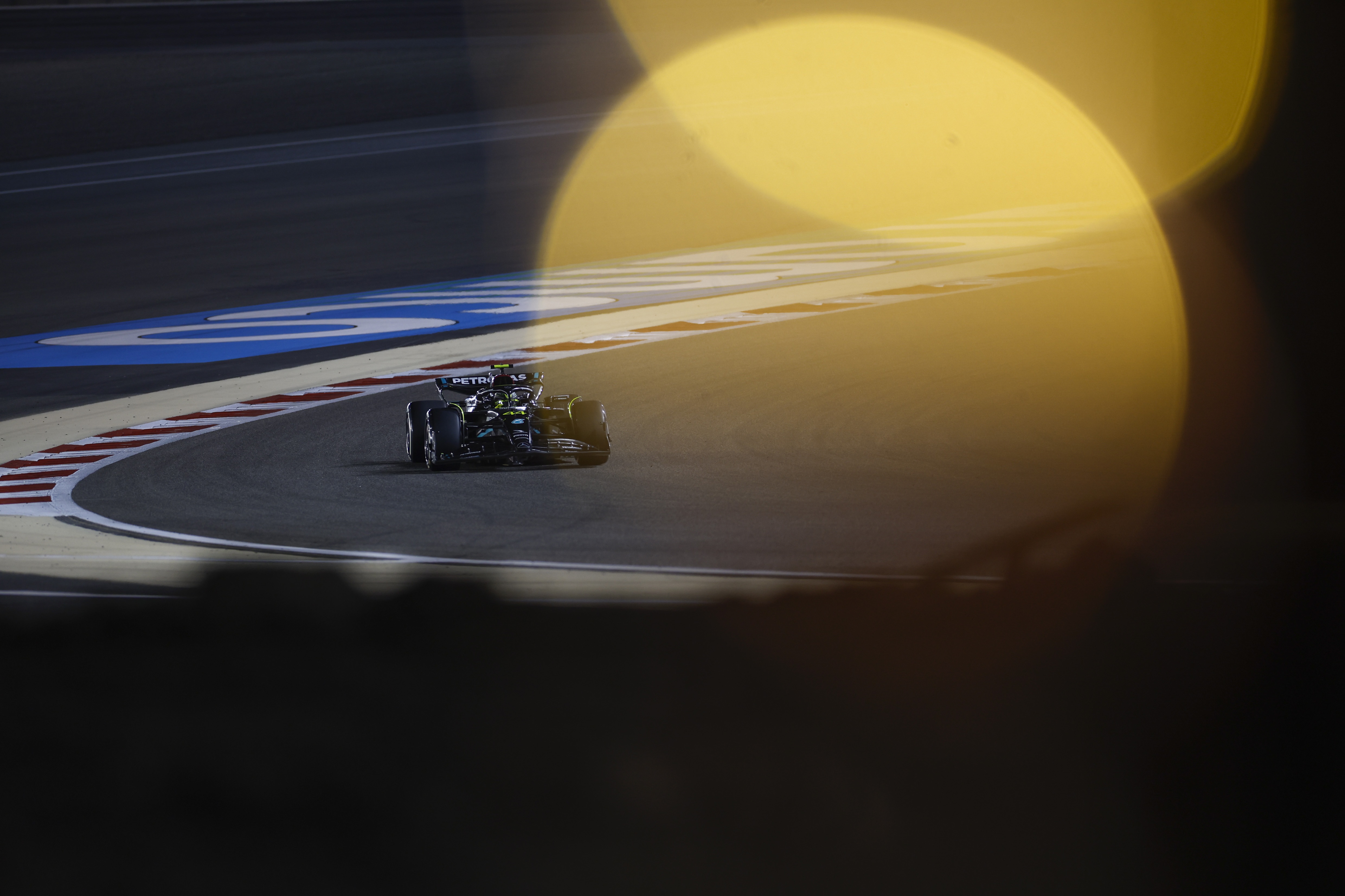 Mercedes F1 car on a race track at night HD Wallpaper