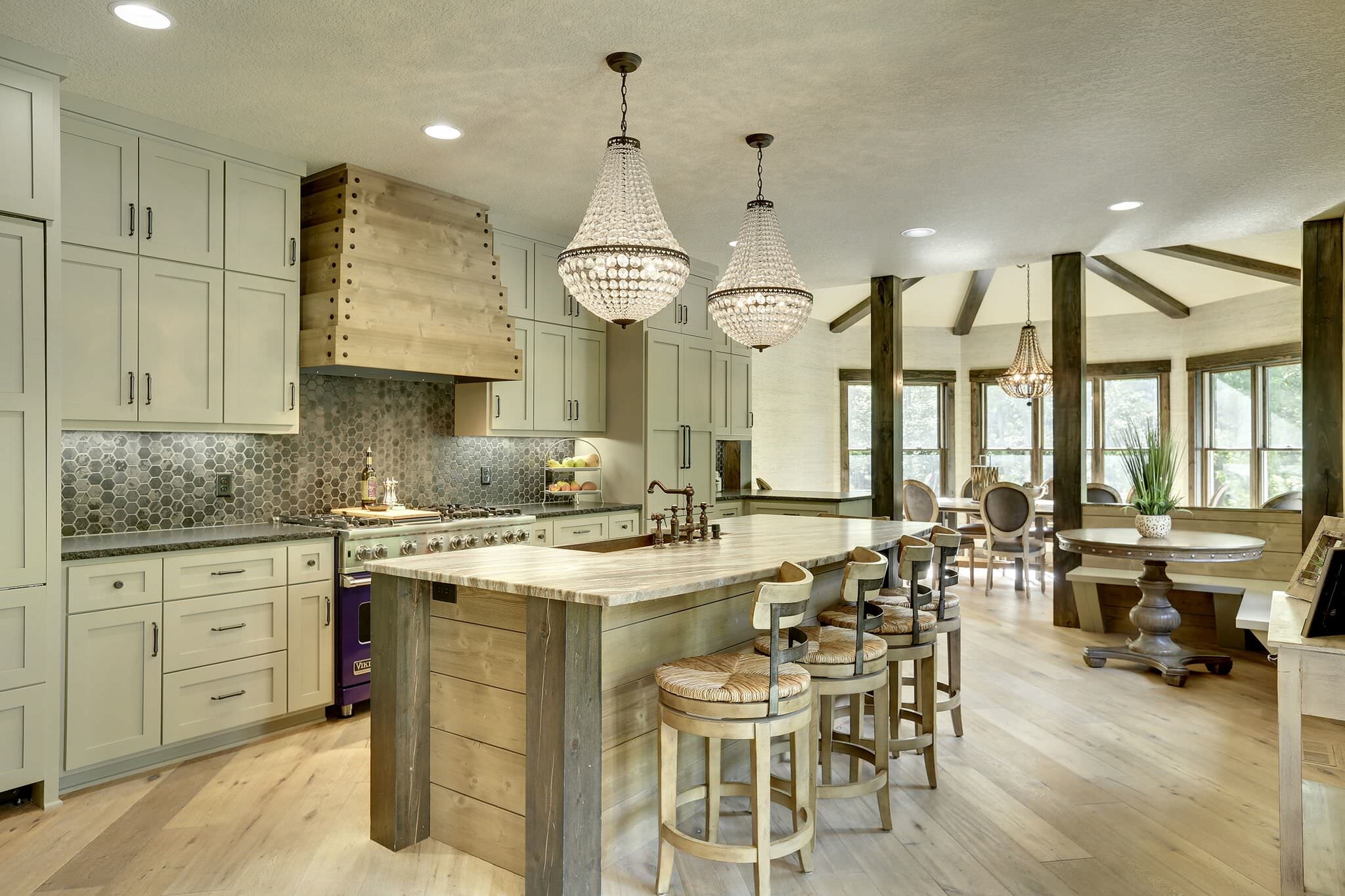 Kitchen with island, chandeliers, and dining area HD Wallpaper