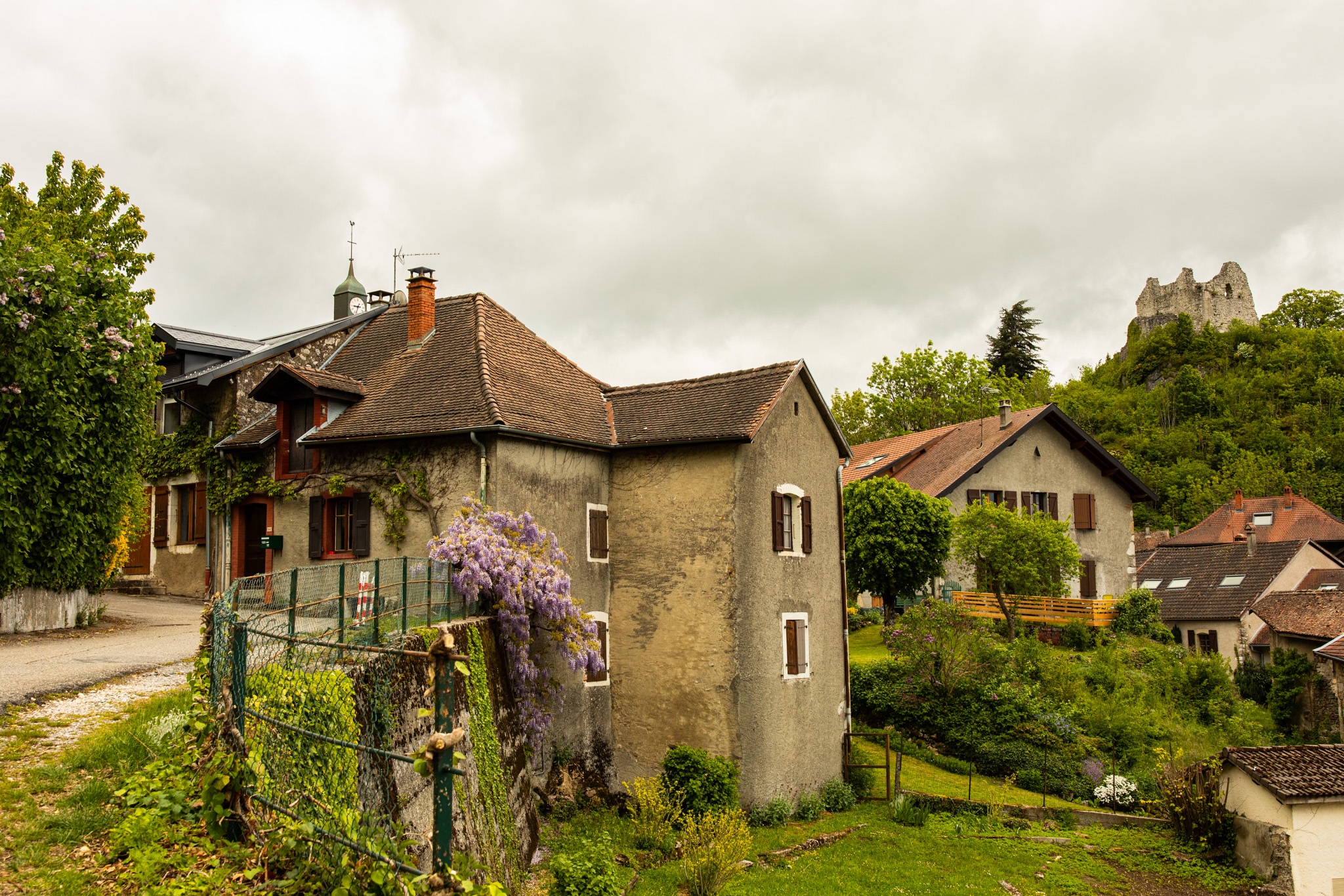 Village with castle ruins on a hill HD Wallpaper