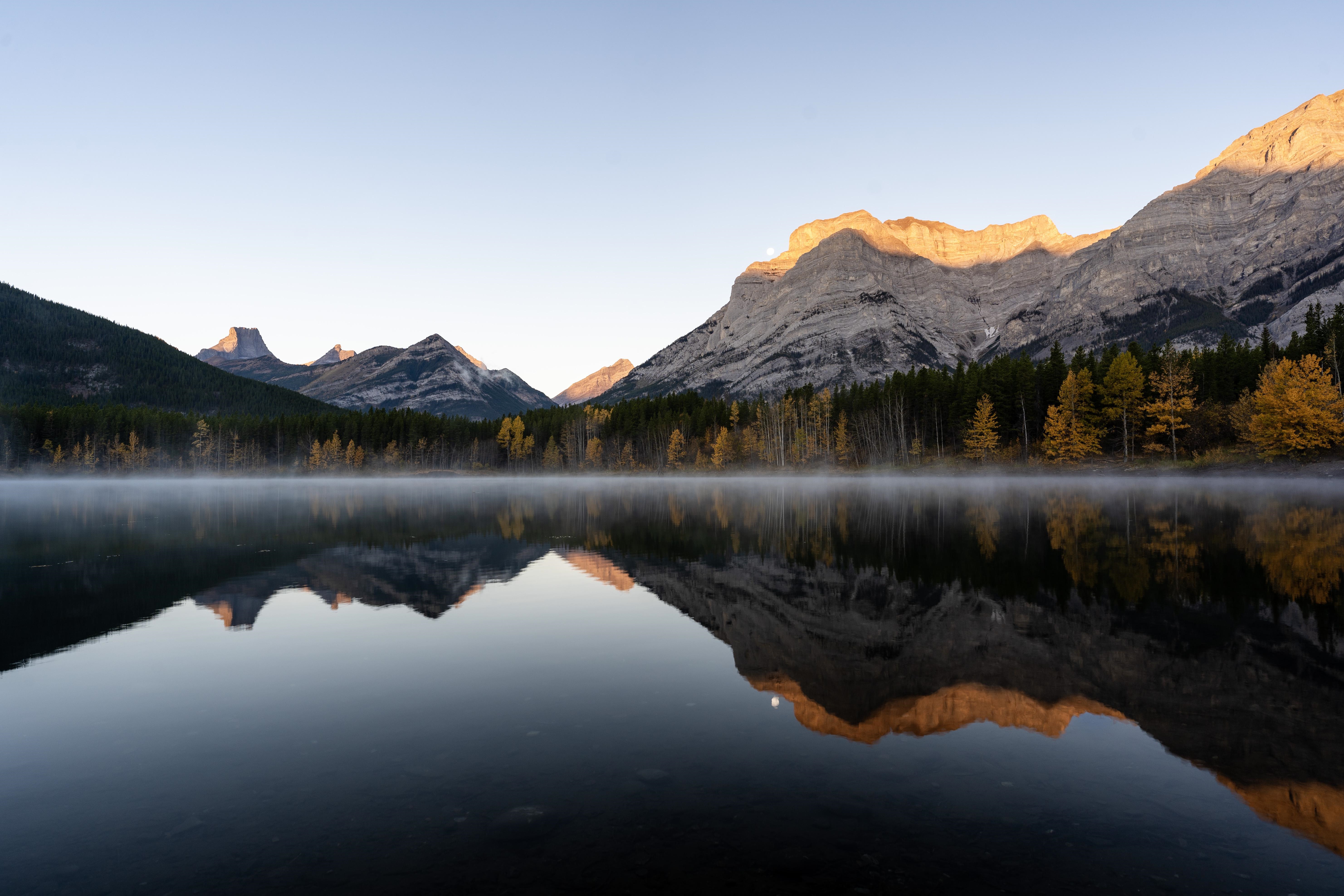 Misty lake reflecting mountains and forest in Canada HD Wallpaper