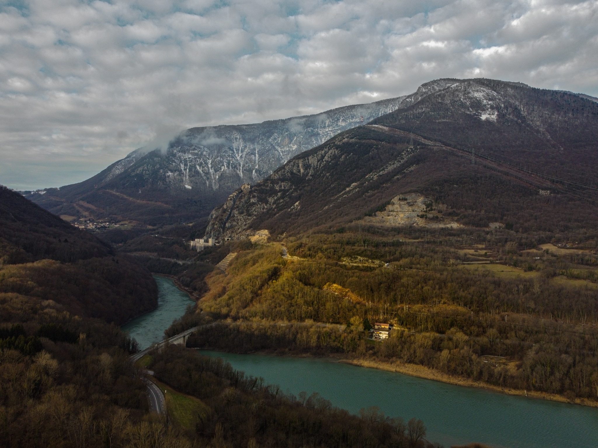 River flowing through a valley with snow-capped mountains HD Wallpaper