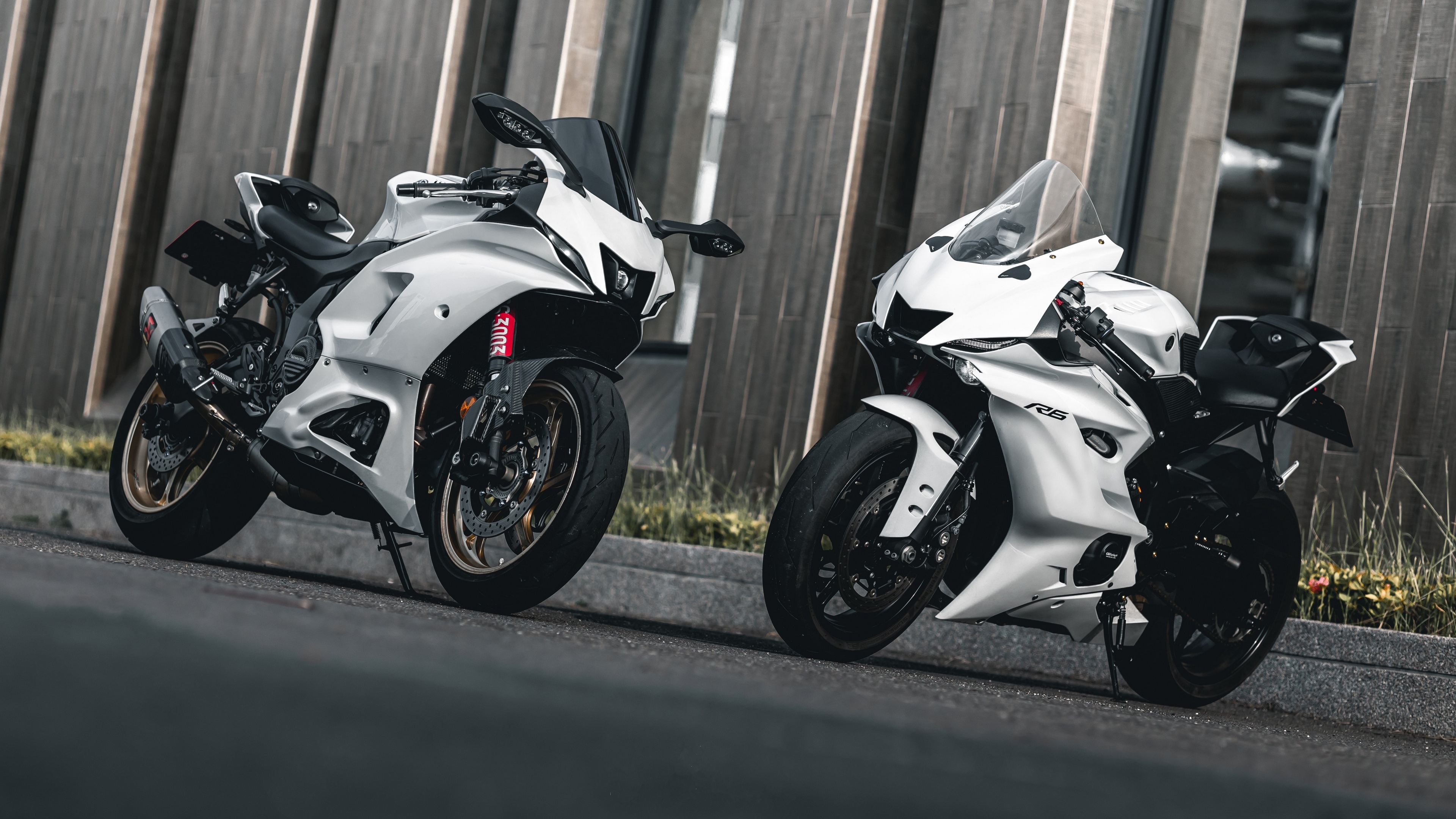 Two white Yamaha YZF motorcycles on a road HD Wallpaper