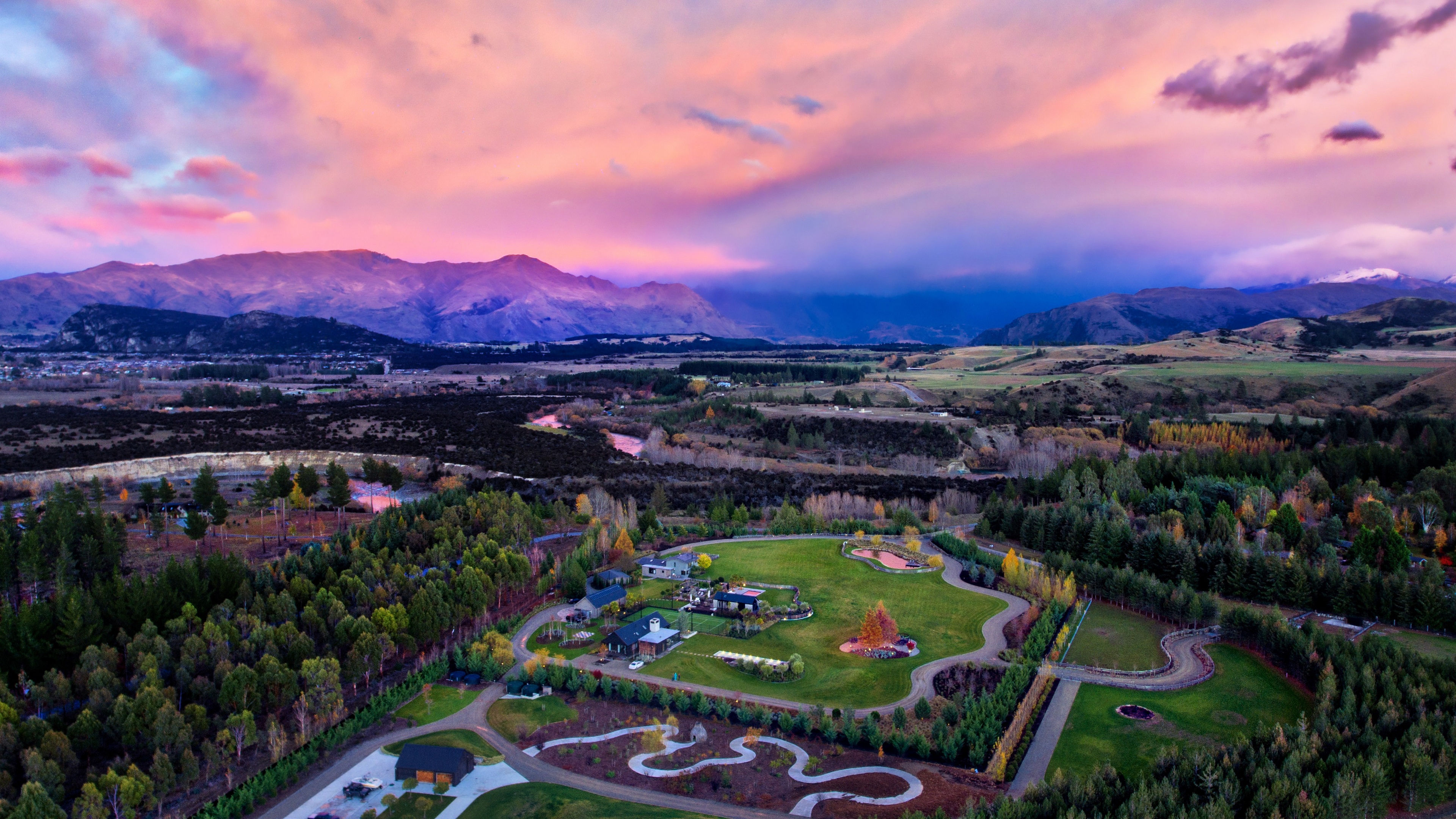 4K sunset over mountains and houses HD Wallpaper