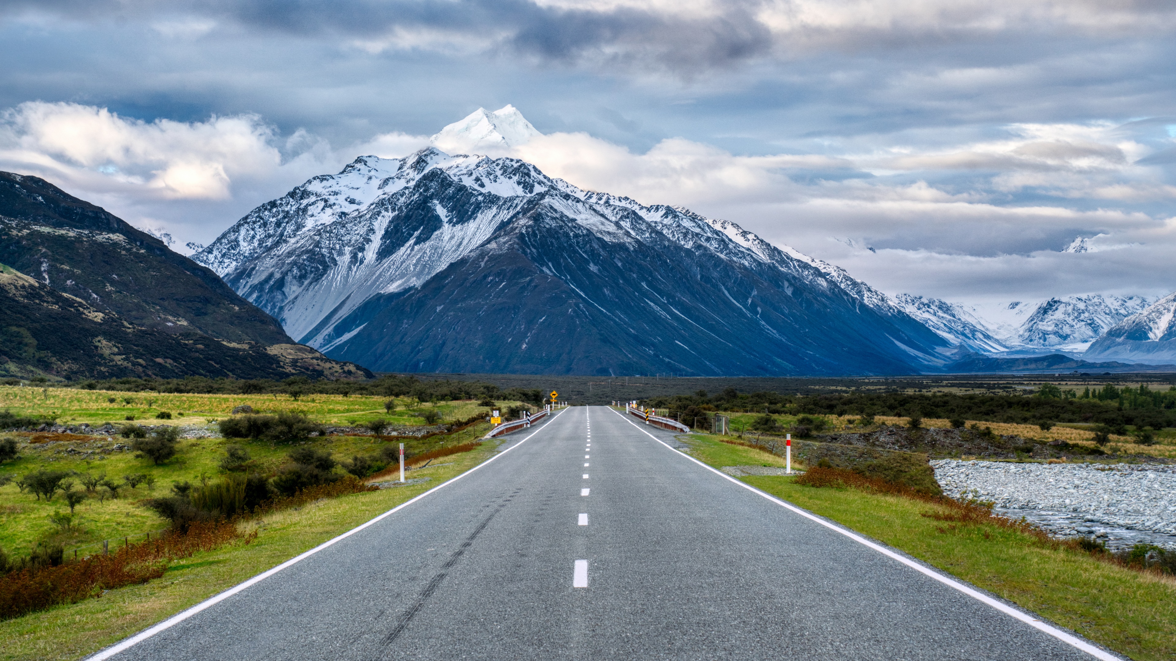 4K road leading to snow-capped mountains in New Zealand HD Wallpaper