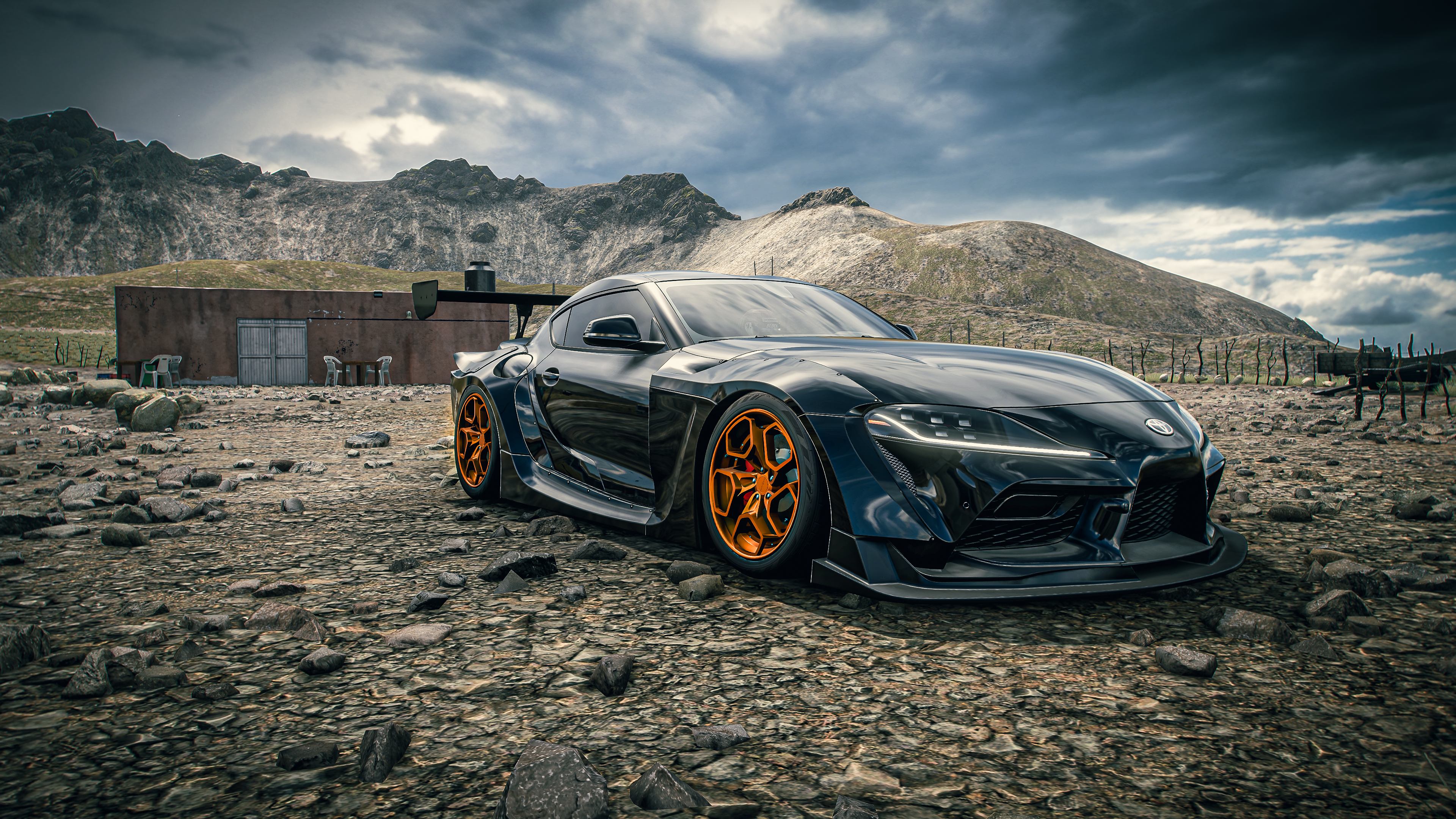 4K Toyota GR Supra in a rocky, mountainous landscape HD Wallpaper