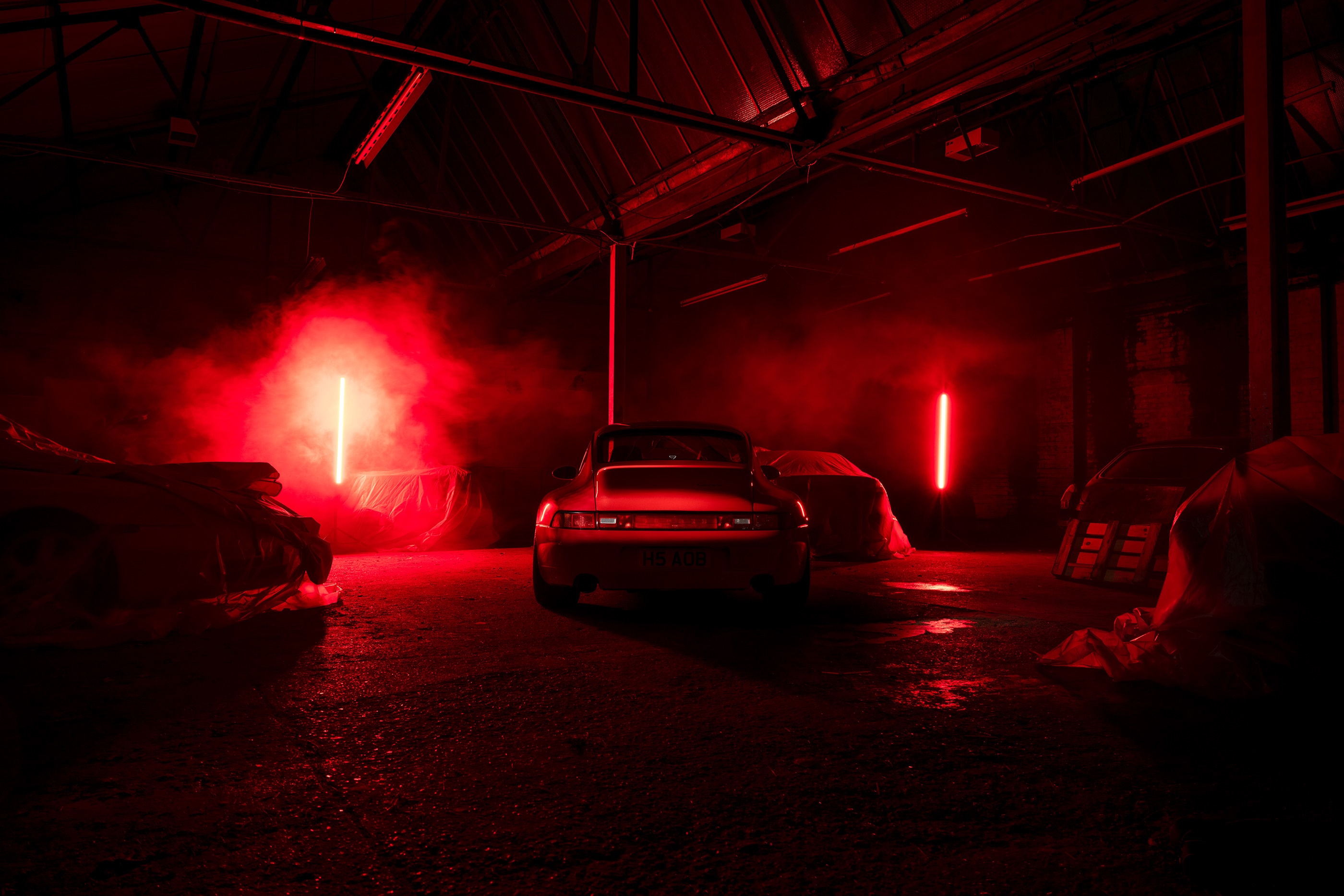 Porsche 911 in a dark garage with red lights HD Wallpaper