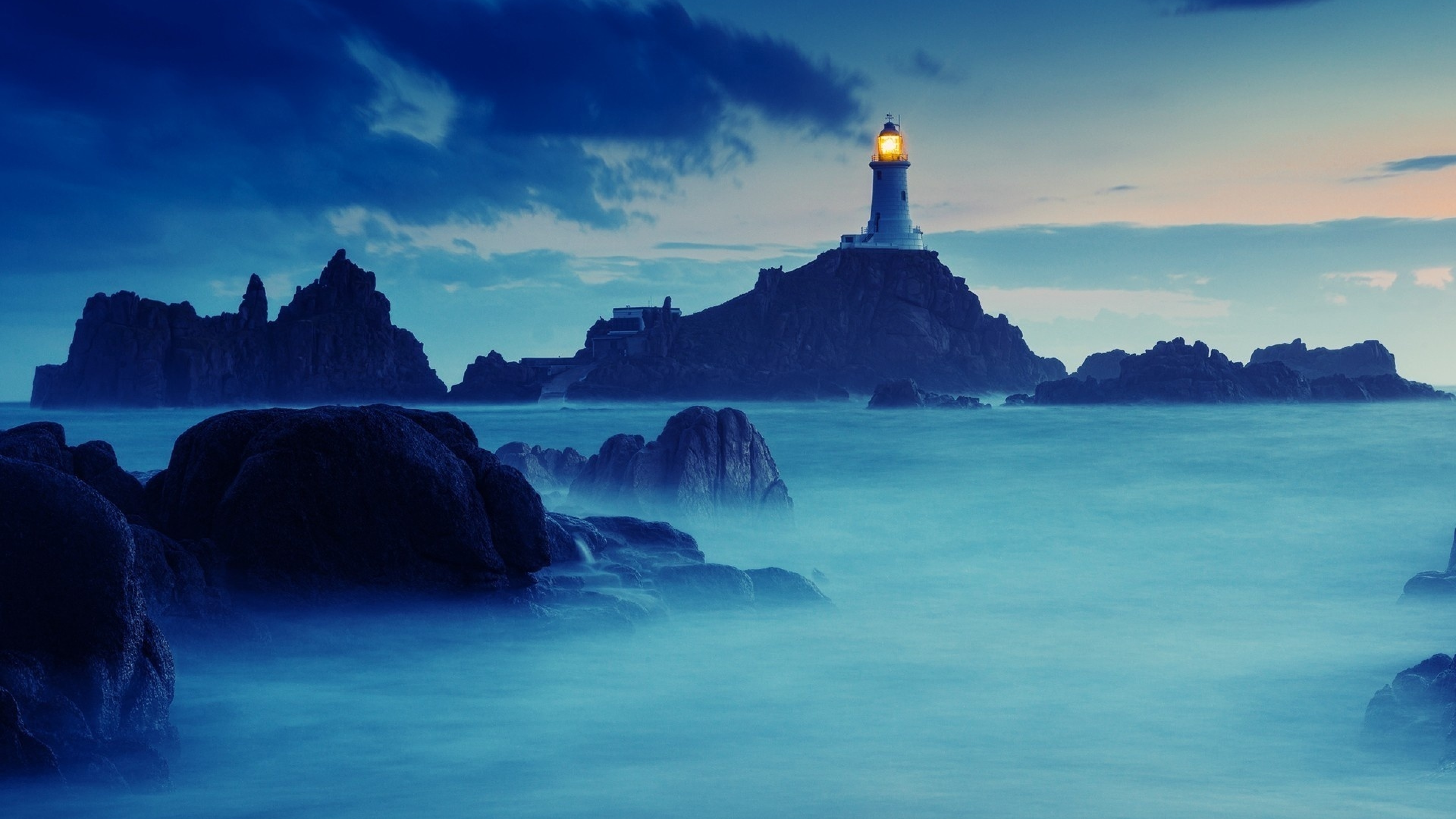 4K Lighthouse on Rocky Island in Blue Water HD Wallpaper