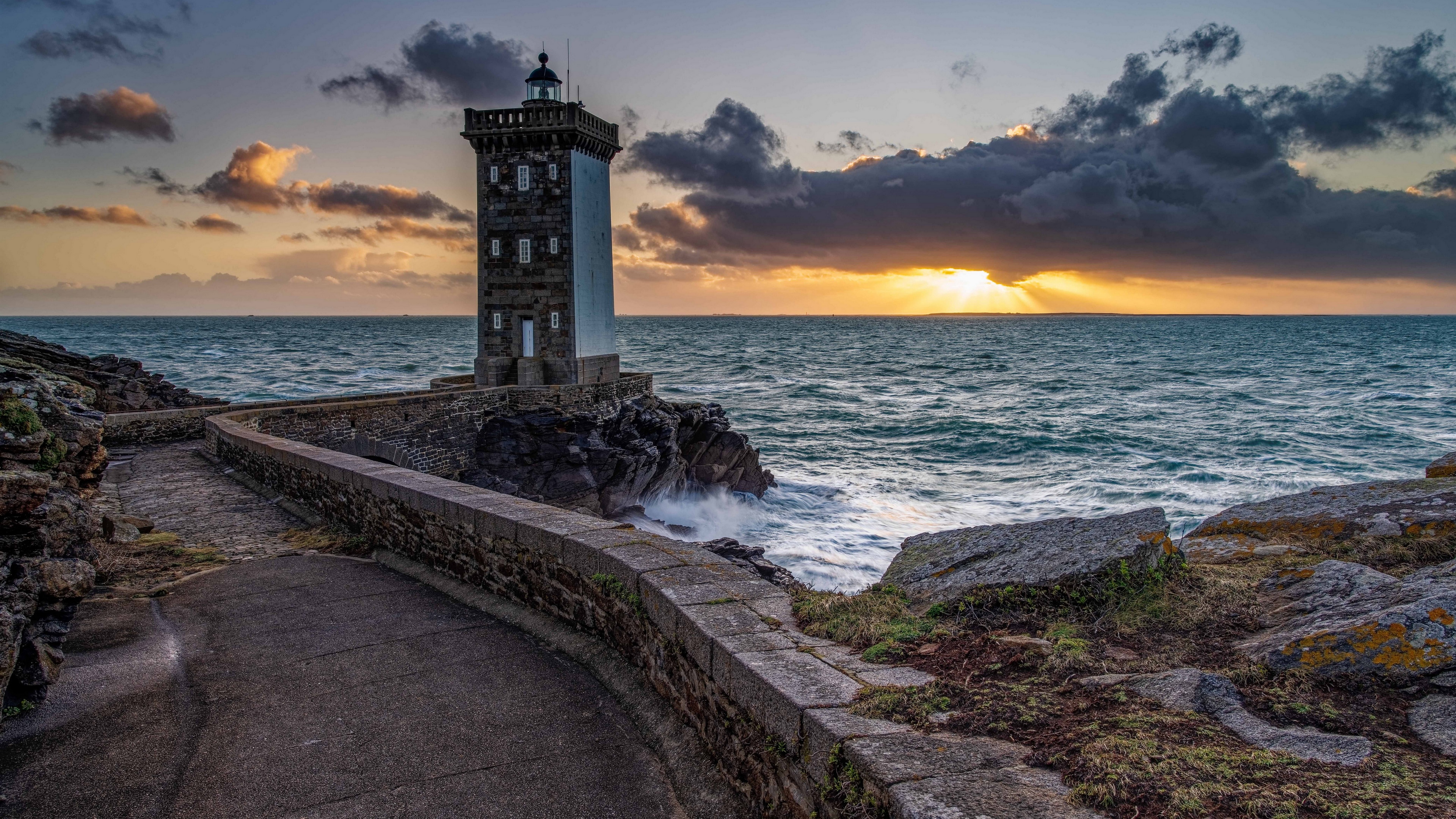 Lighthouse on the coast at sunset HD Wallpaper