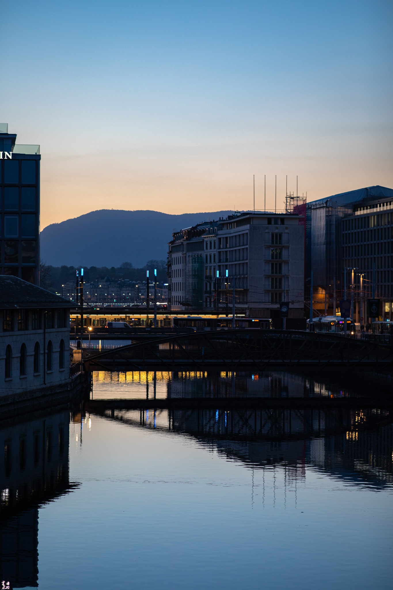 Cityscape with river and mountains at twilight HD Phone Wallpaper