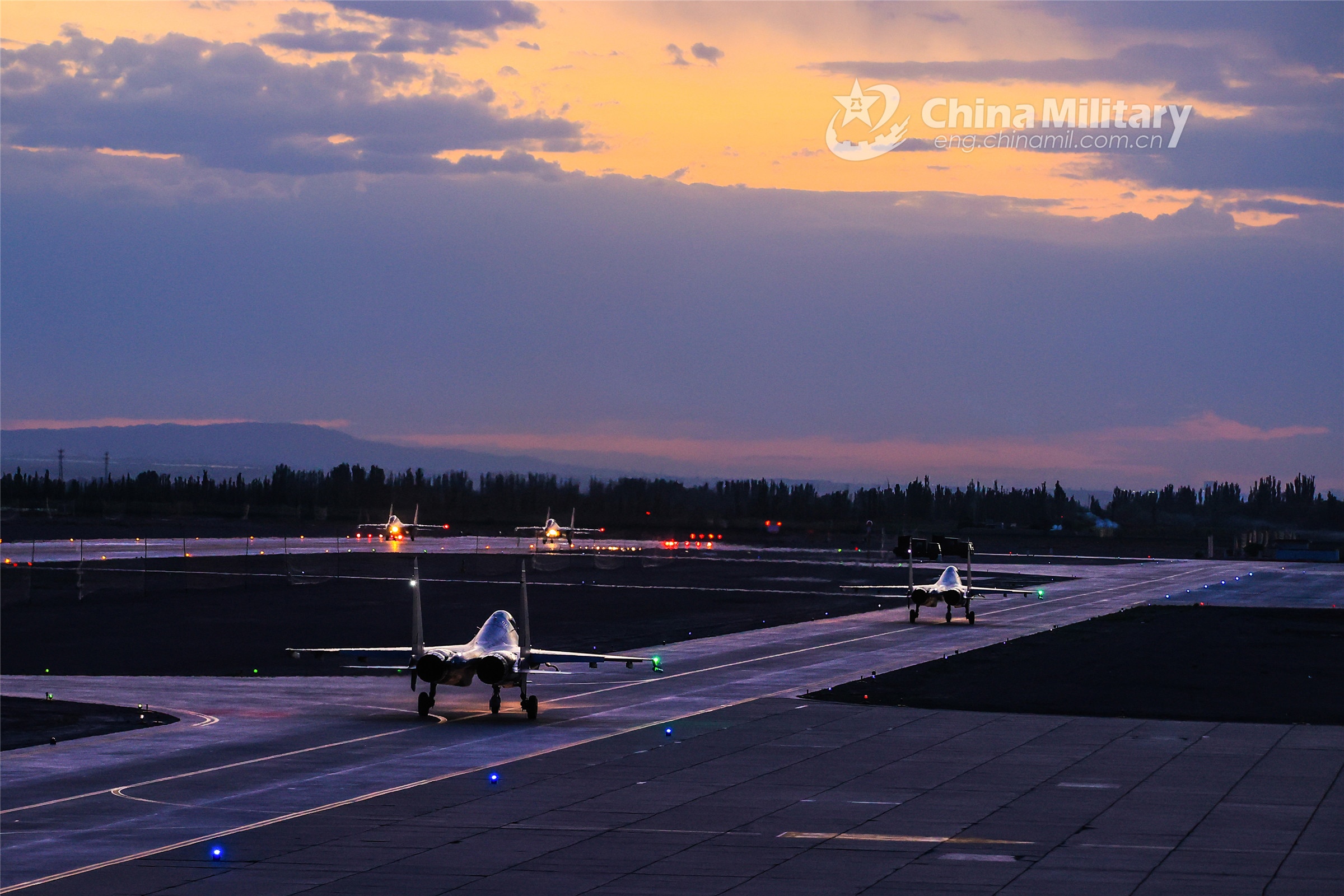 Chinese military aircraft on runway at dusk HD Wallpaper