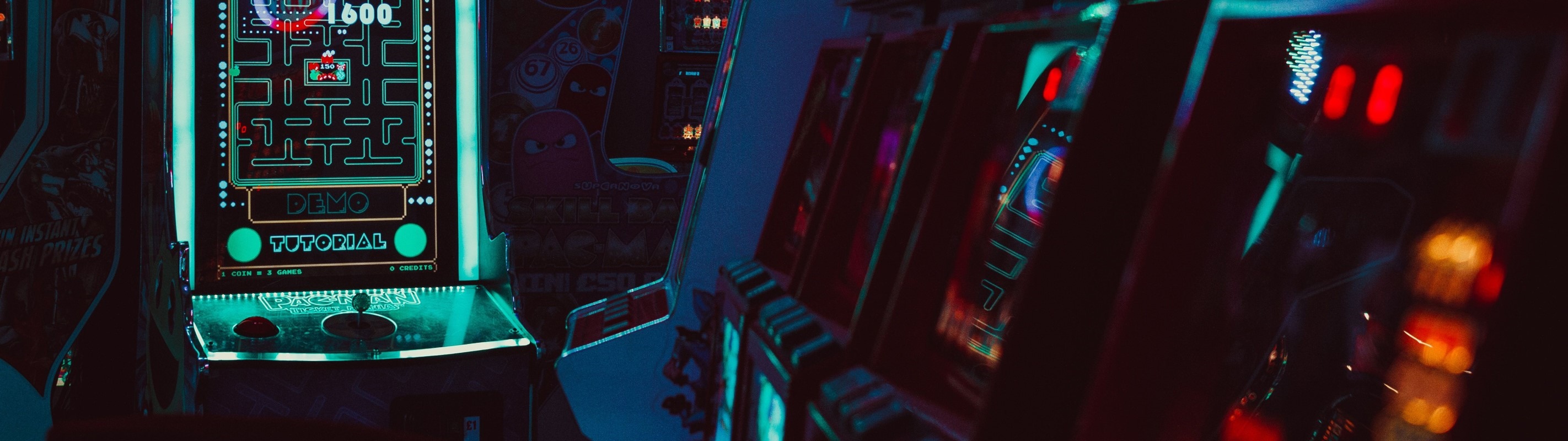 Pac-Man arcade cabinet in a retro arcade HD Wallpaper