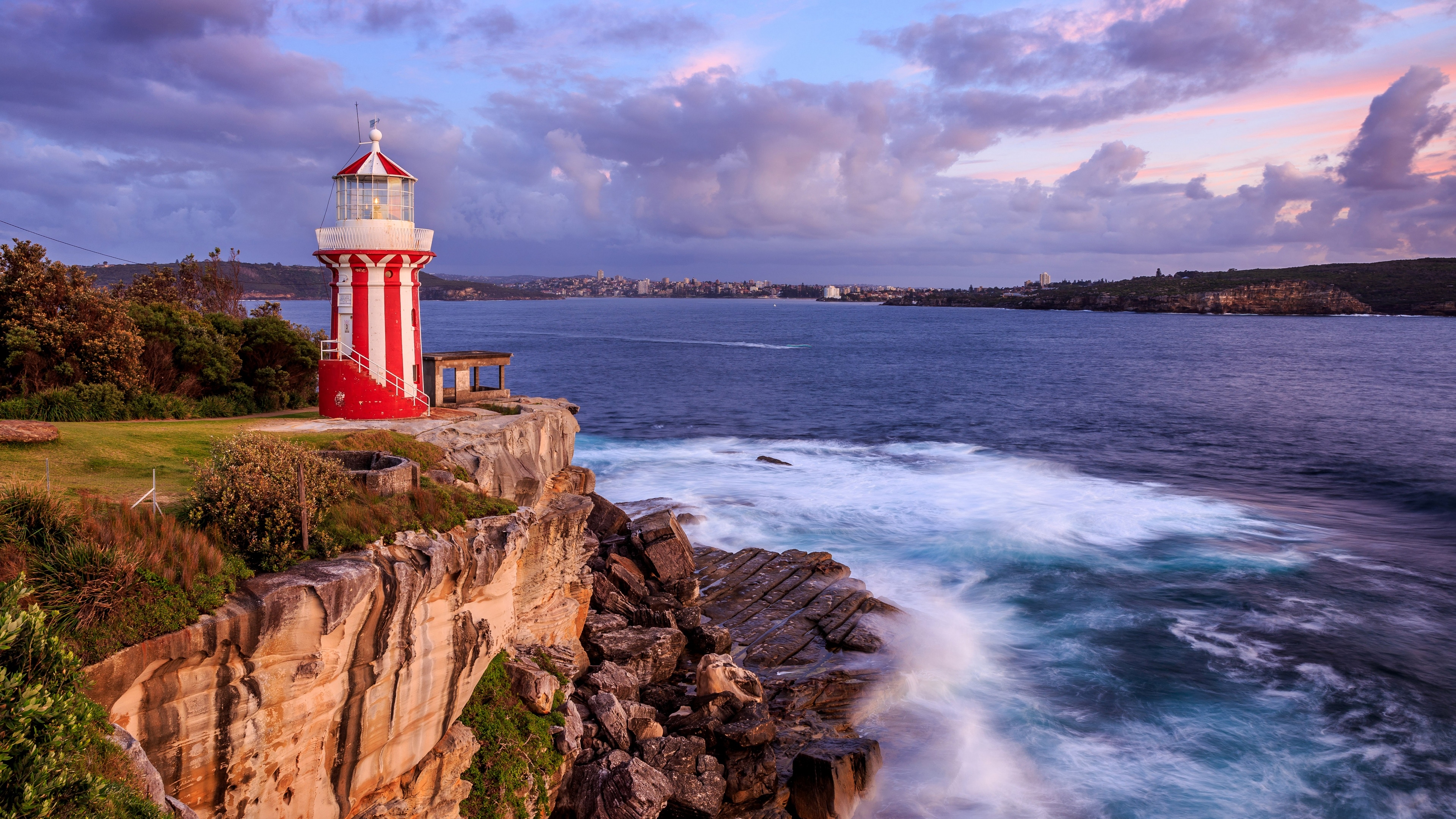 Red and white lighthouse on a cliff overlooking the sea in Sydney HD Wallpaper