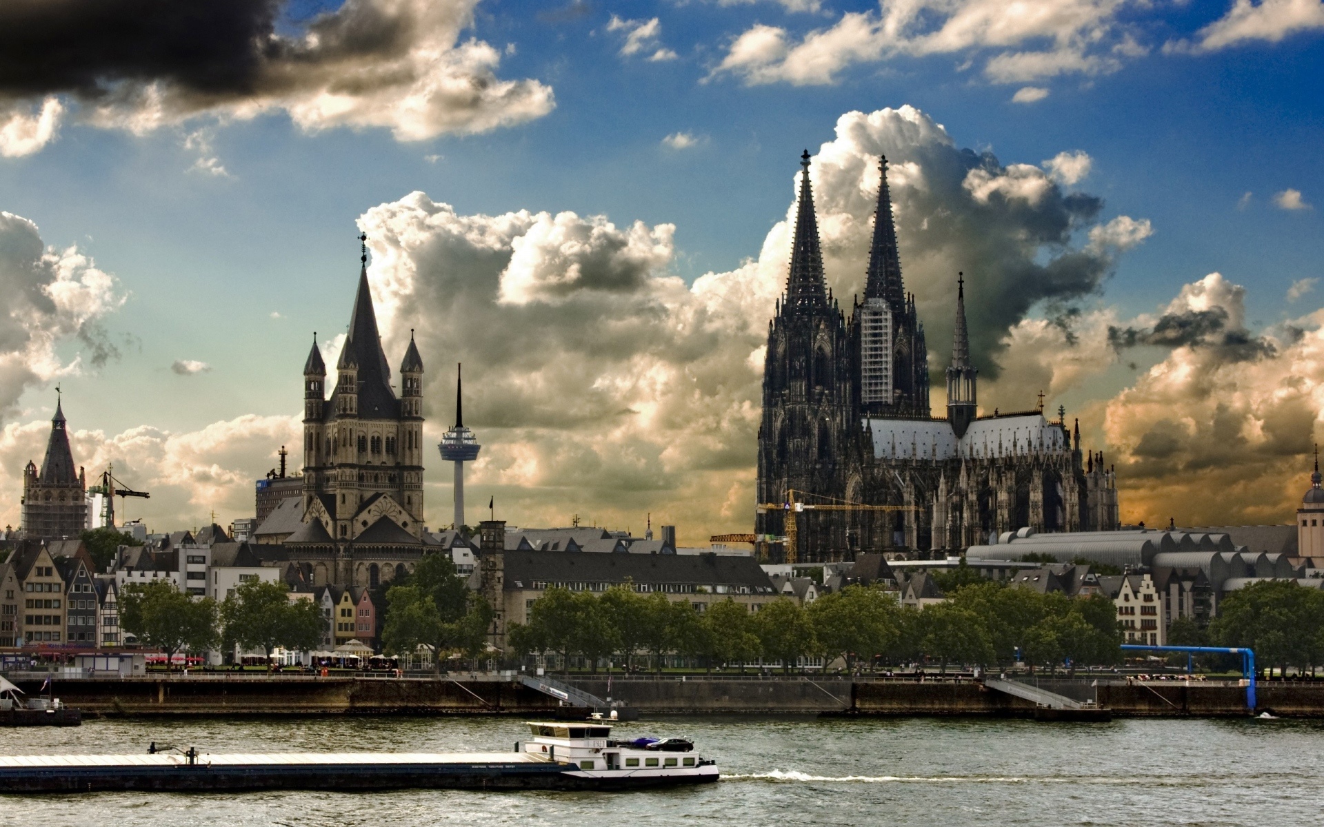 Cologne Cathedral and cityscape with river barge HD Wallpaper