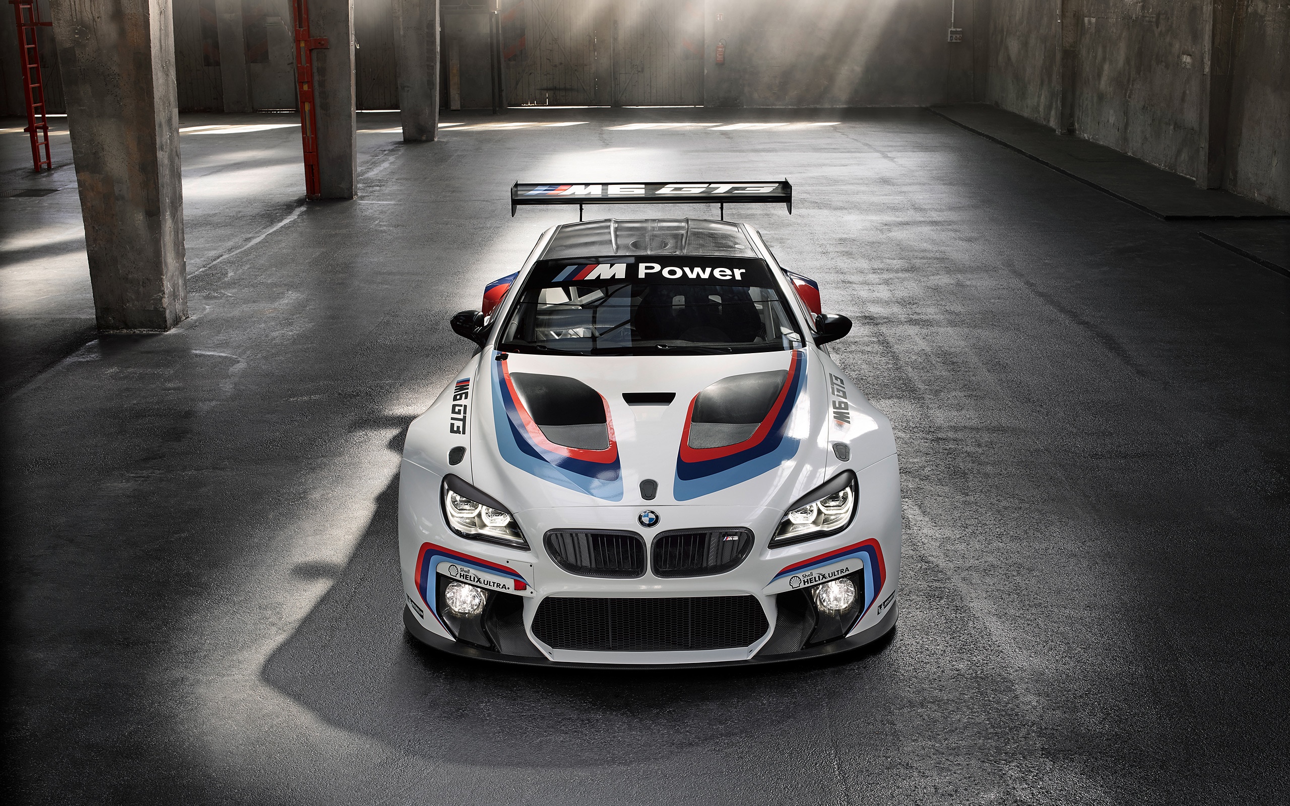 BMW M6 GT3 race car in a warehouse HD Wallpaper