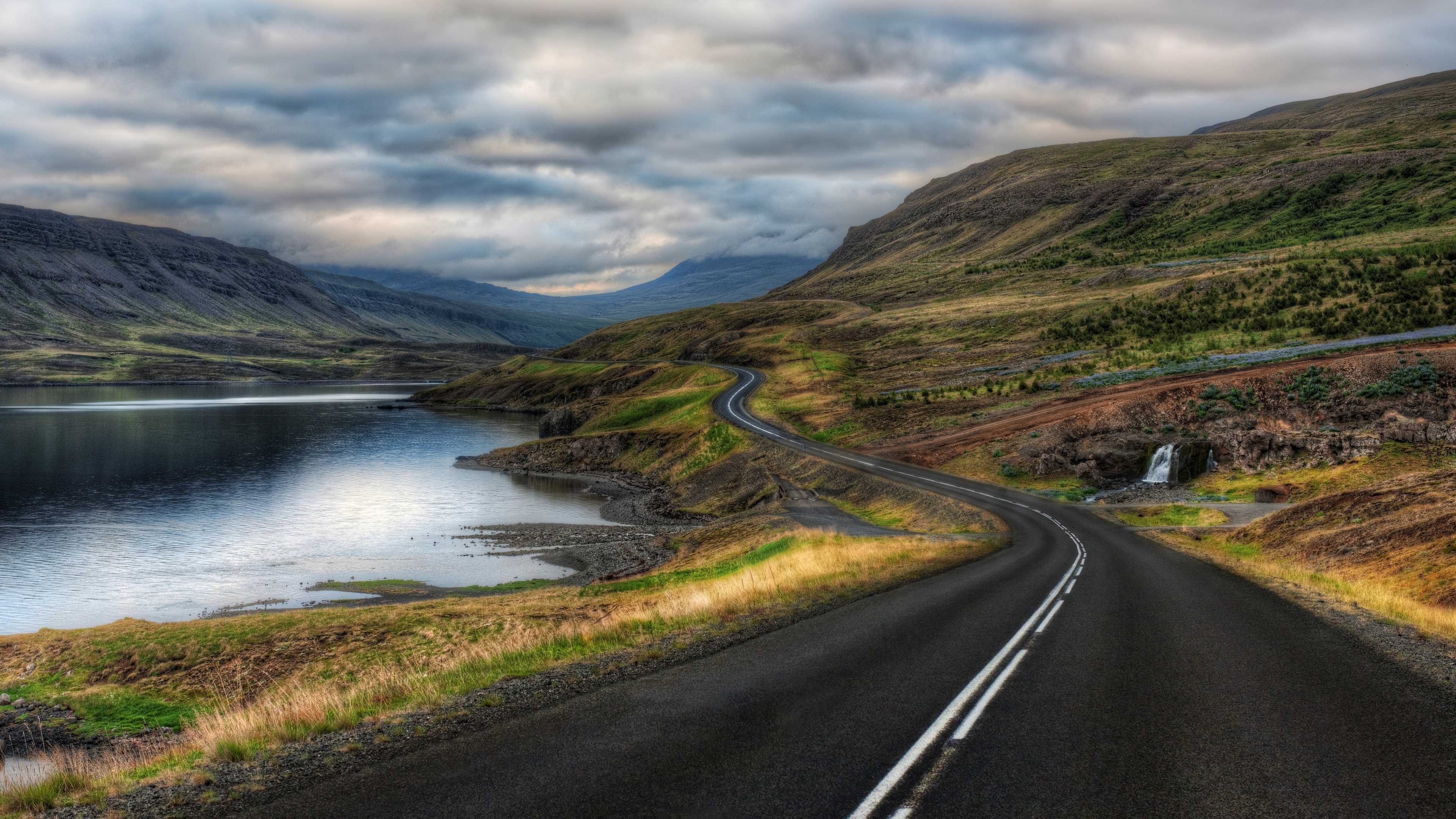 4K Iceland landscape with mountains, road, and water HD Wallpaper