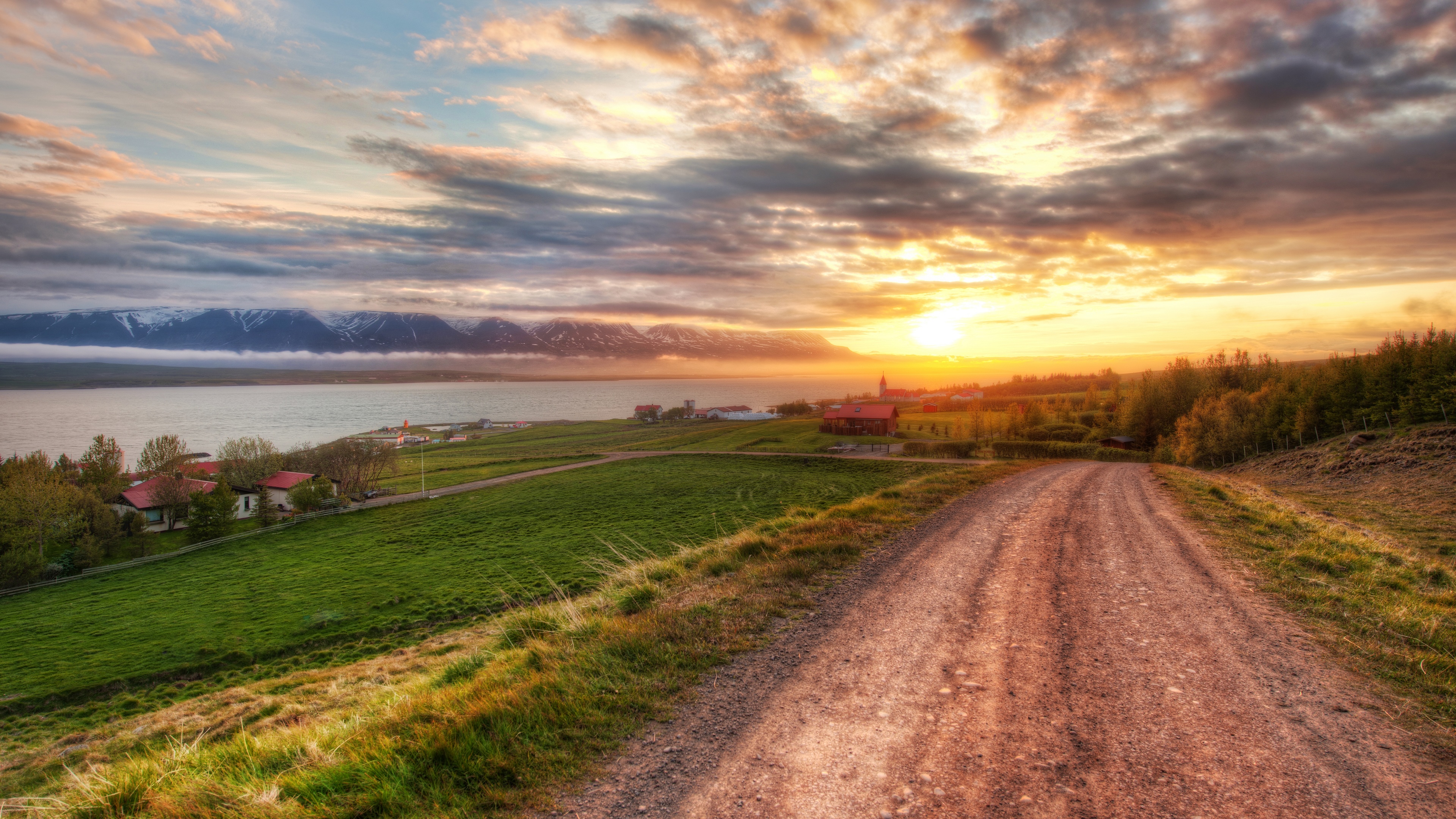 4K Iceland village at sunset with mountains and road HD Wallpaper
