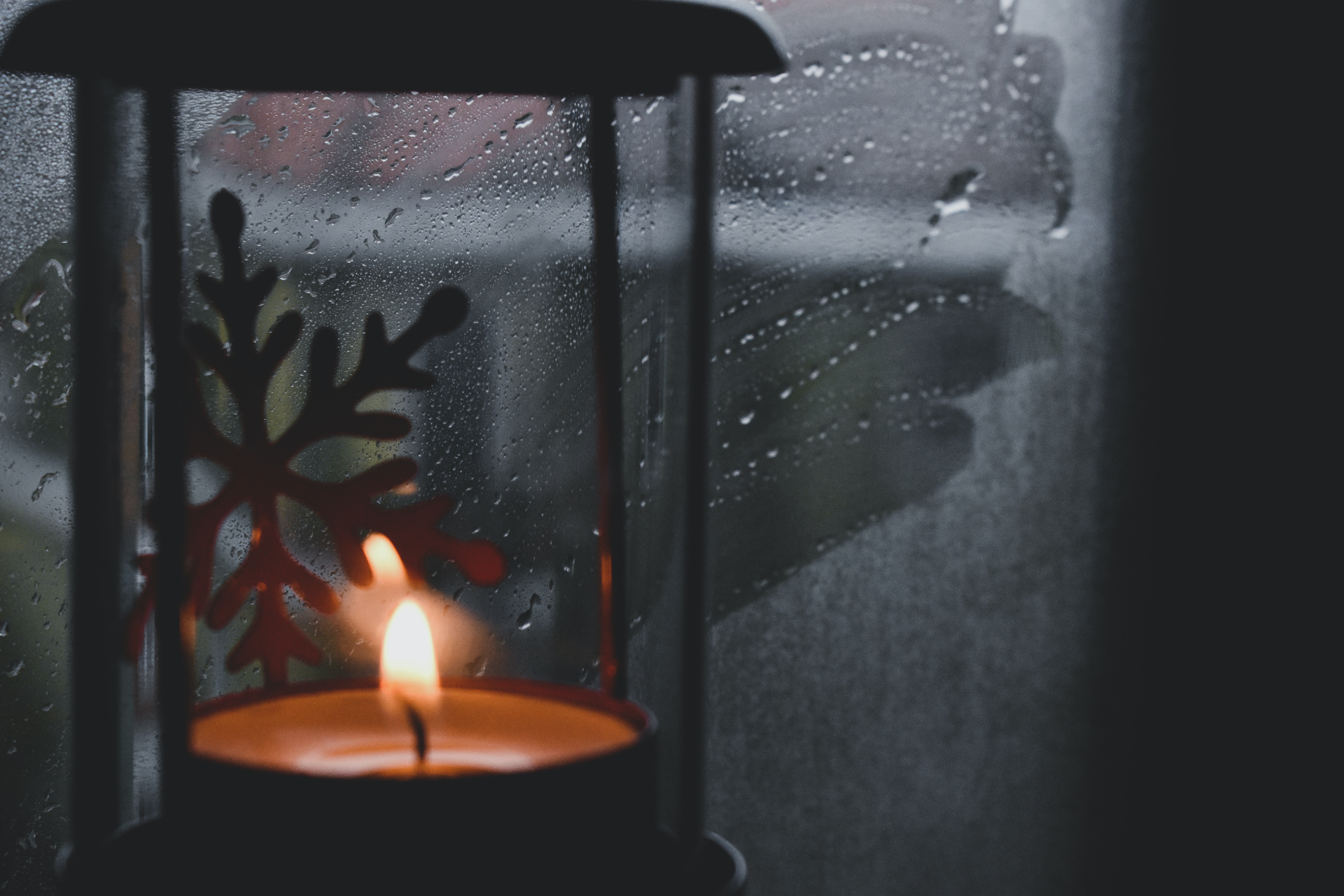 Candle lantern with snowflake on a rainy window HD Wallpaper